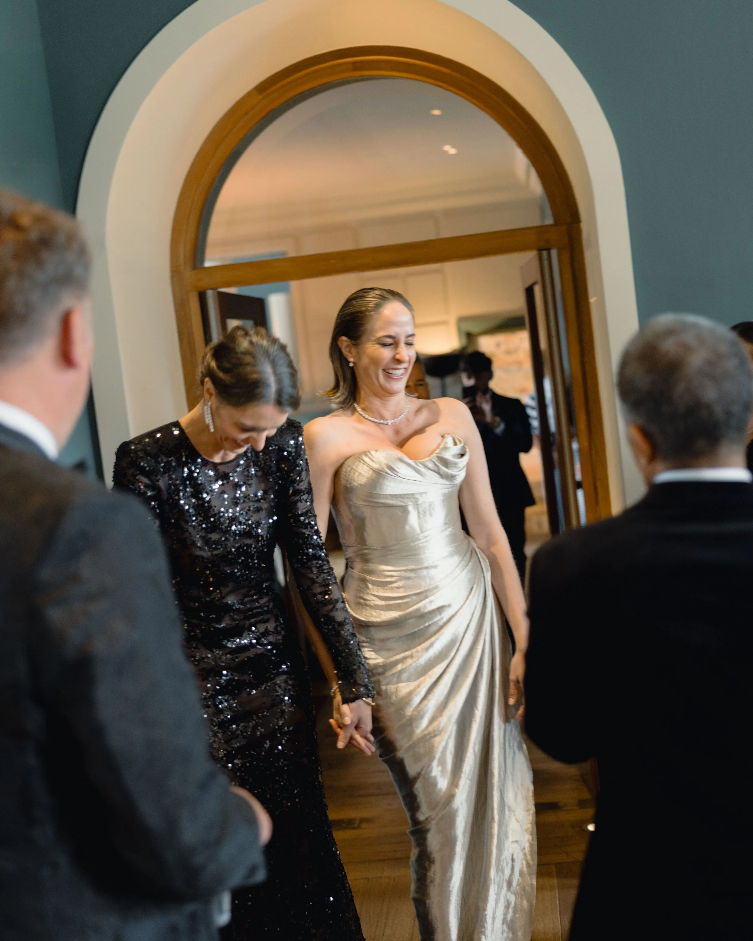 The brides make their entrance to dinner at Cowley Manor Experimental.