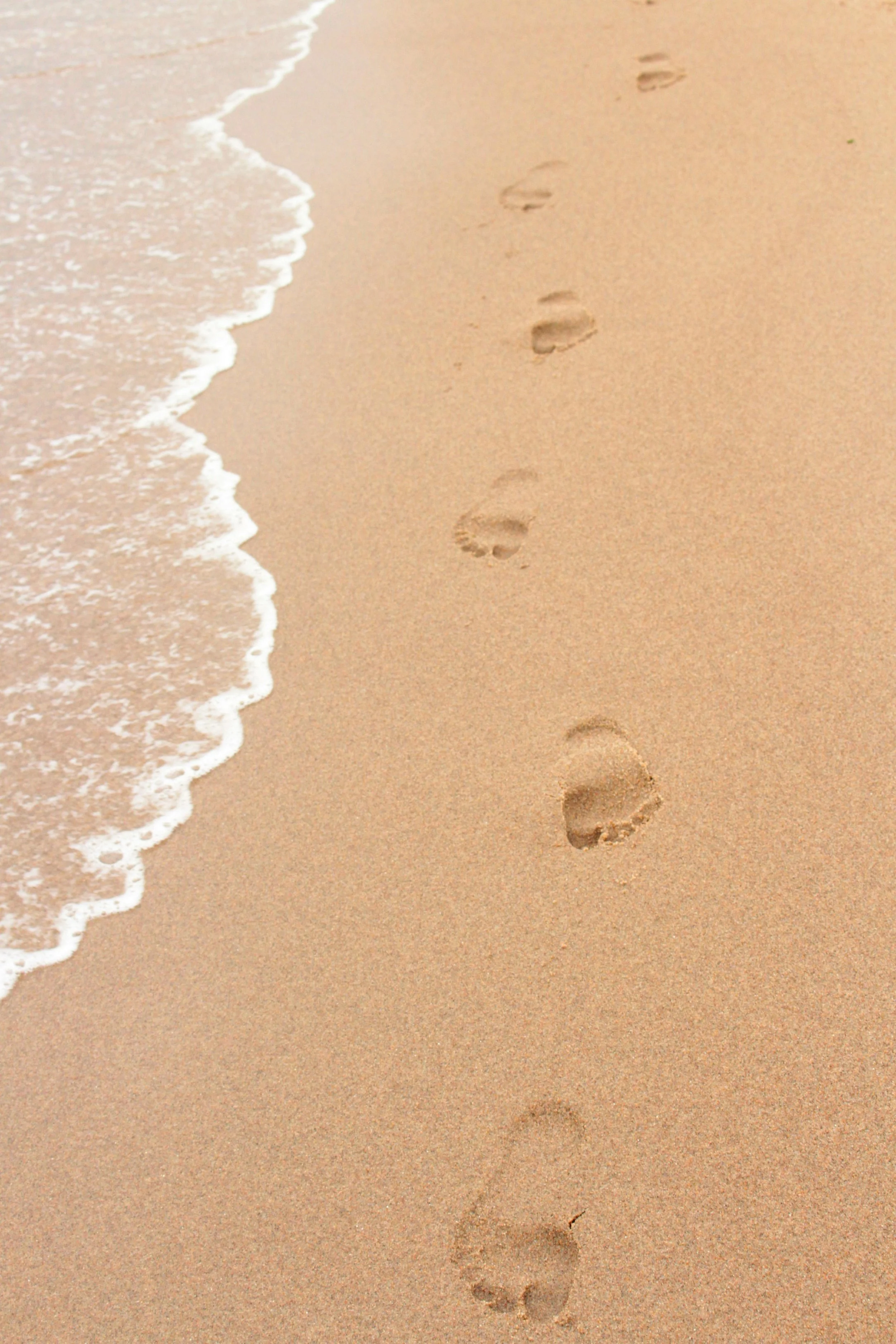 Footprints in sand symbolizing therapeutic integration and aftercare support.