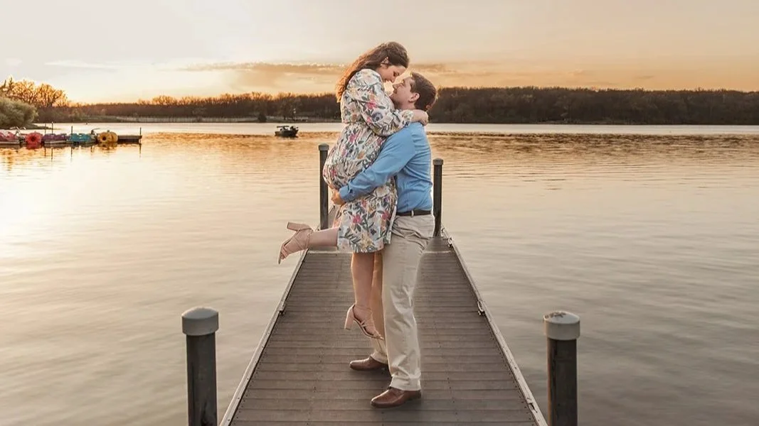 Engaged couple embracing on a dock at sunset at Rock Cut State Park near Rockford, IL.