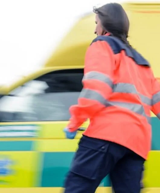 Image: Blurred ambulance with emergency worker
