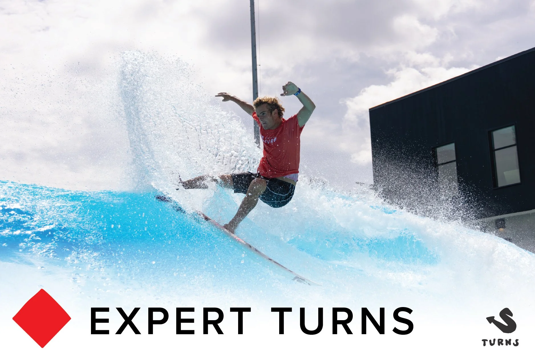 Person surfing on a wave at Atlantic Park water attraction with a large, modern water park structure in the background.