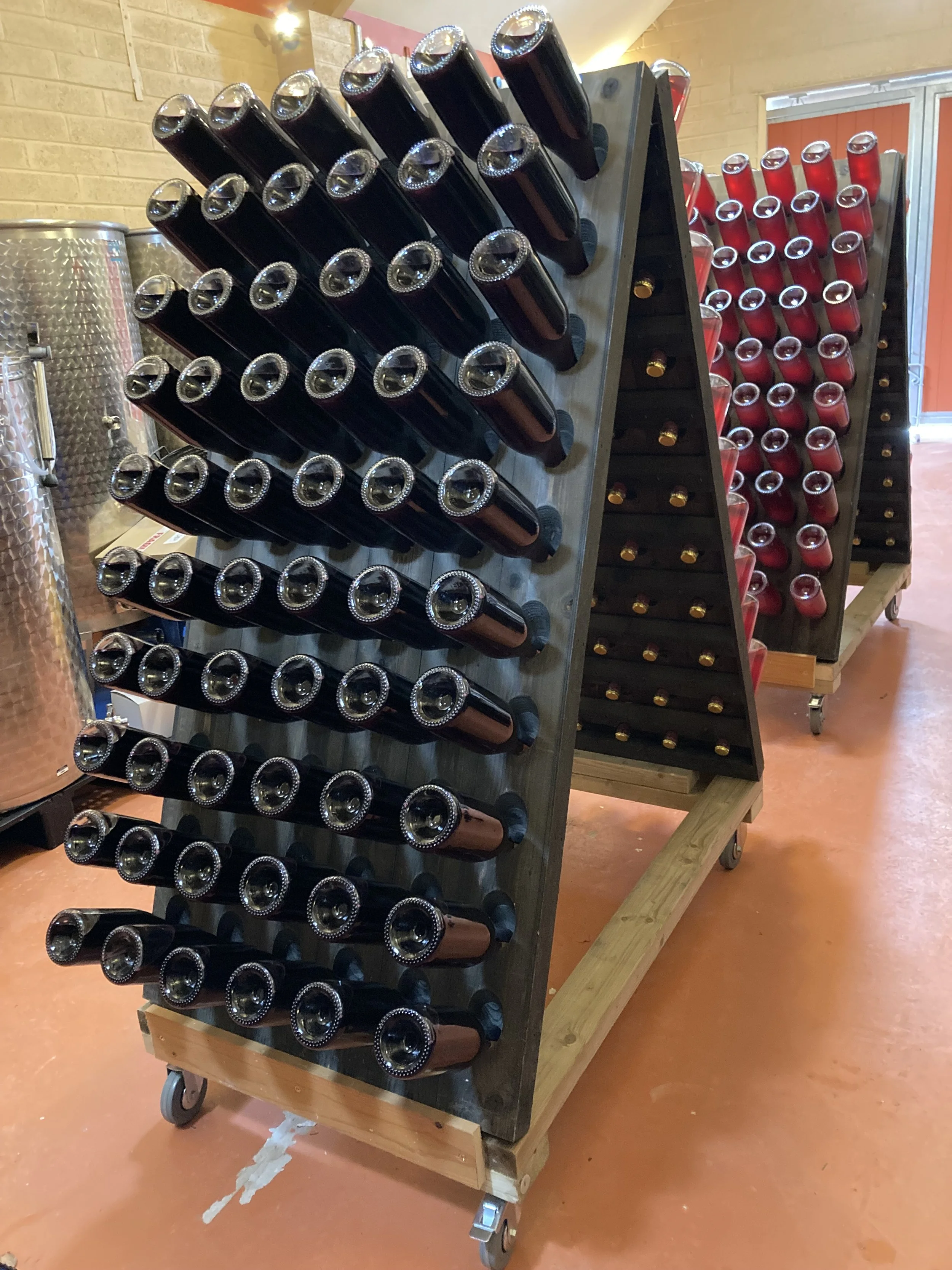 Wine bottles being disgorged on pupitres.jpeg