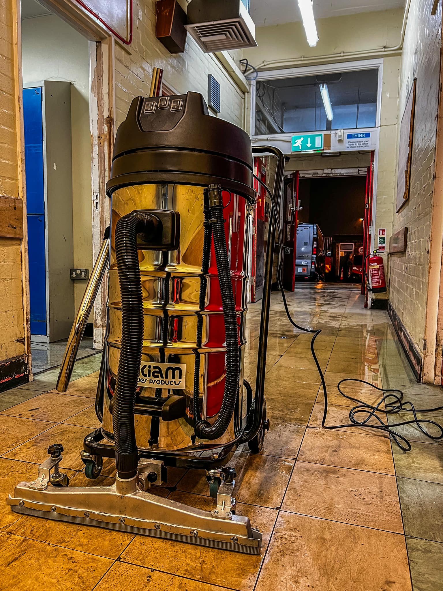 Floor cleaning machine in a hallway inside a building.