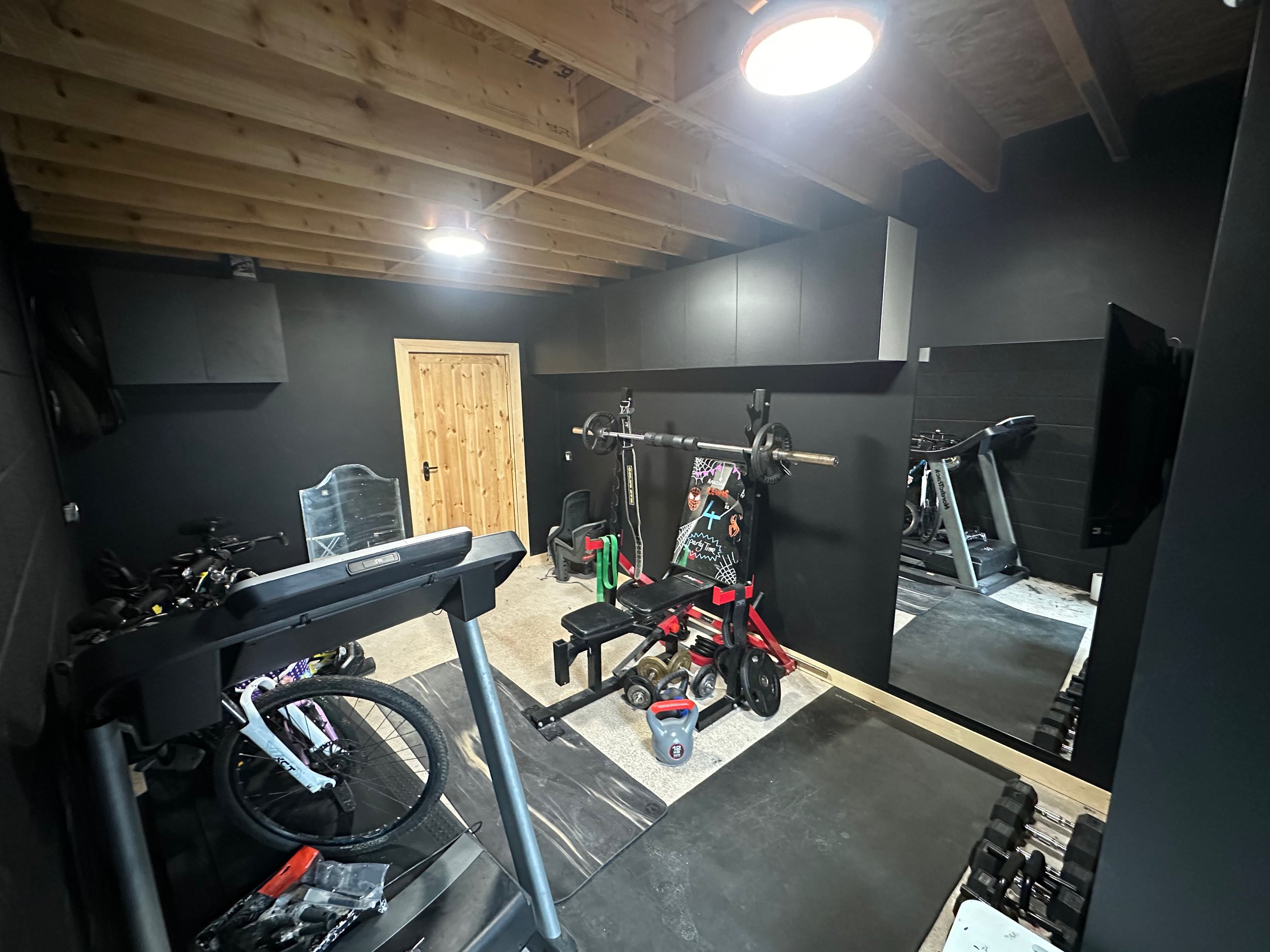 garage conversion into gym with plasterboarded walls and skirting