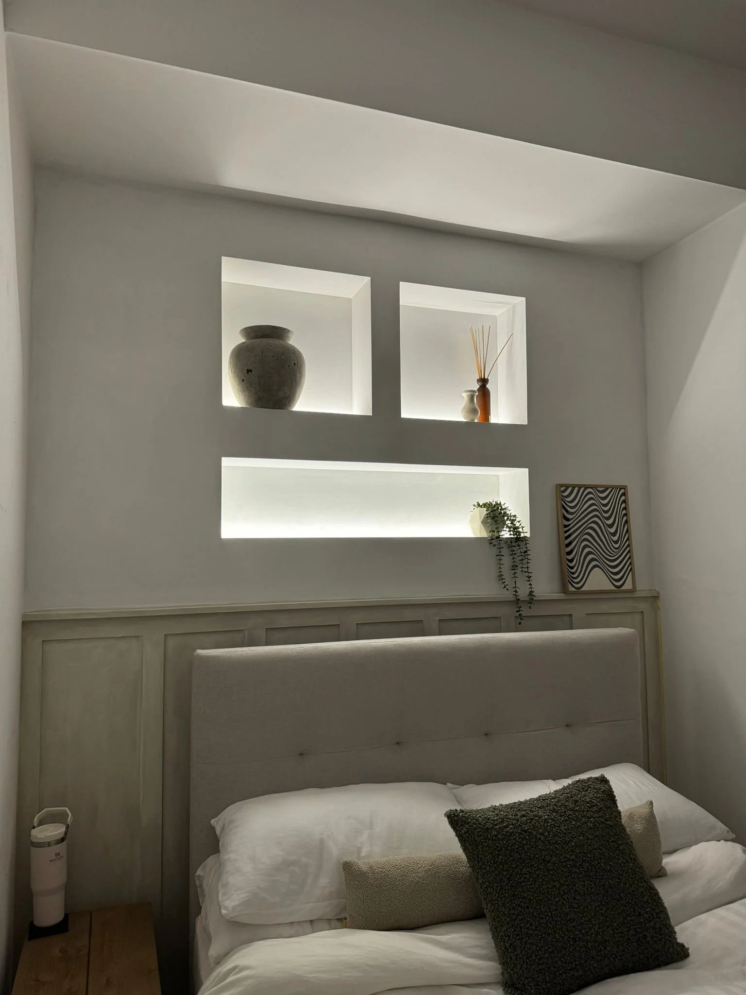 Bedroom feature wall with panelling and LED lit niches