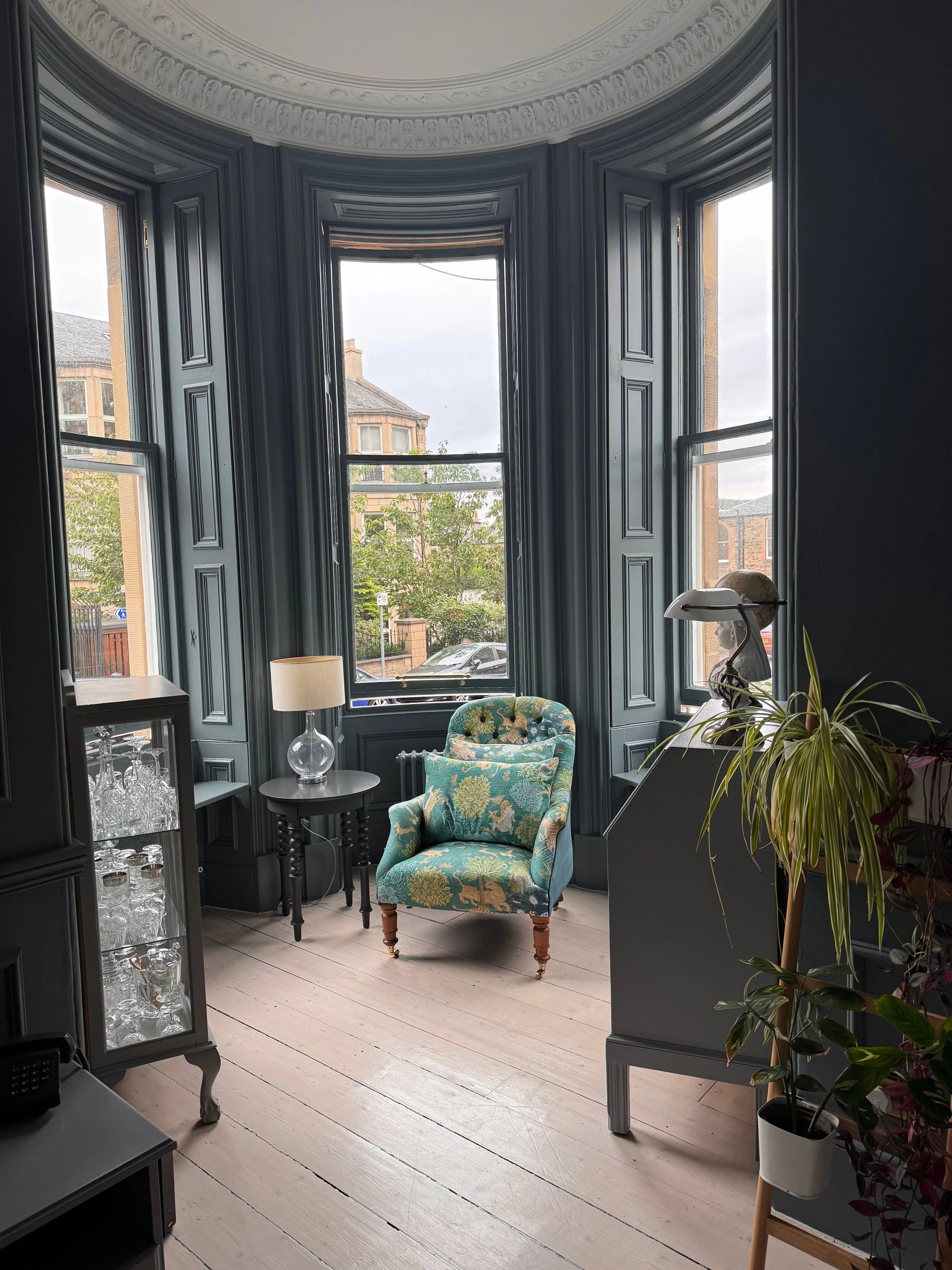 full height panelling in turret of living room 