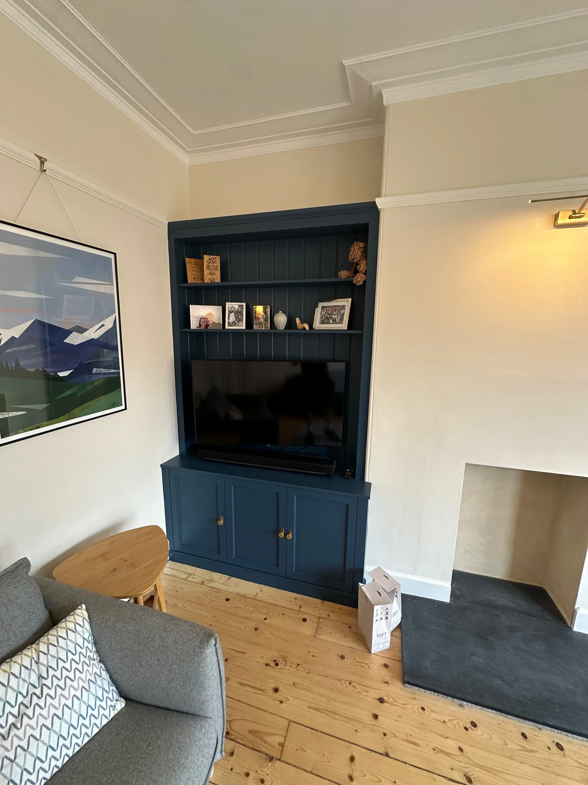 Fitted bespoke alcove unit with storage and book shelving