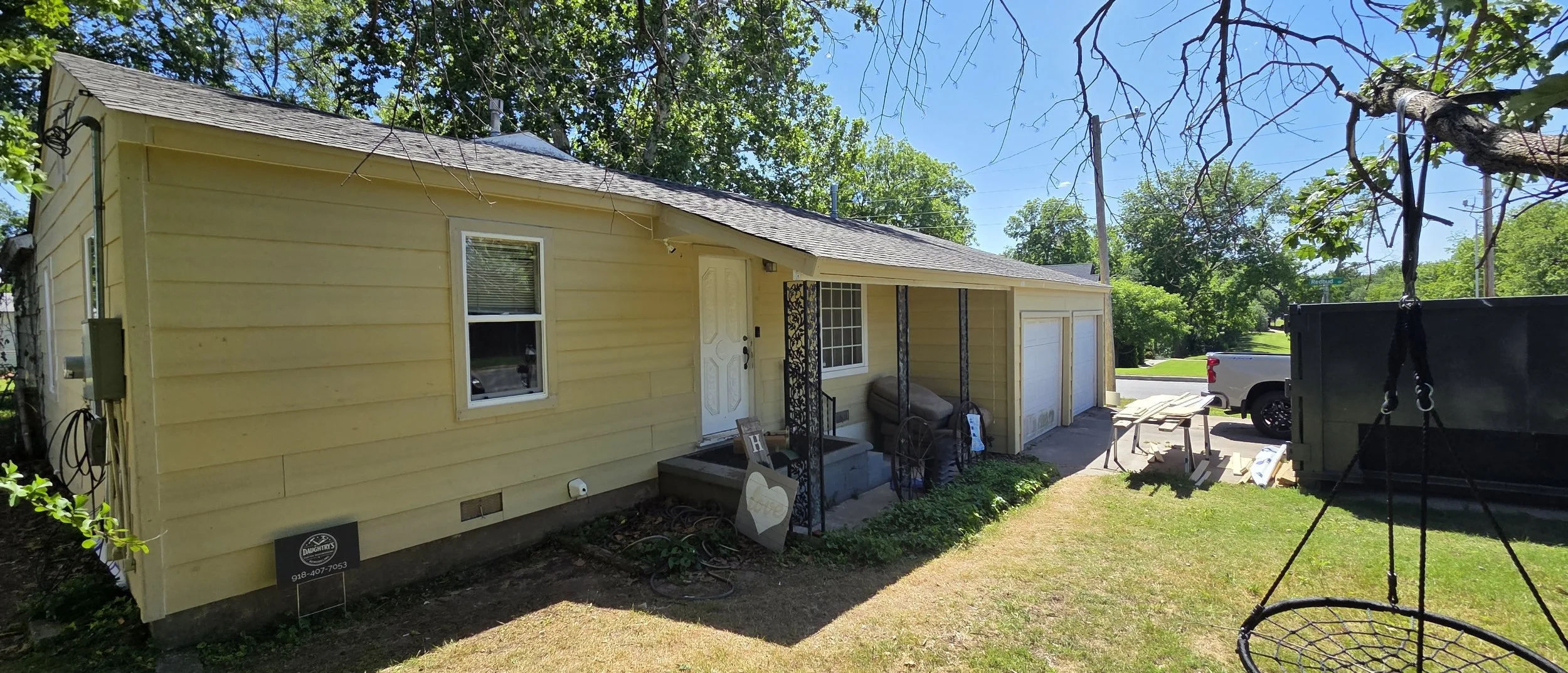 Home exterior during siding, window, door and front porch renovation