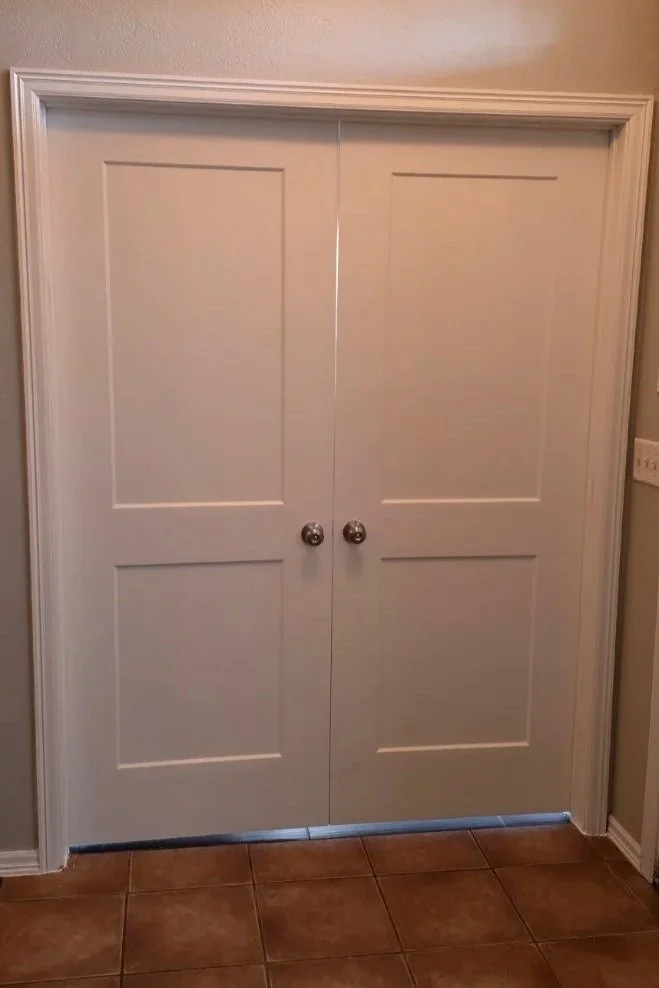 Custom double doors with shaker-style panels and finished interior trim