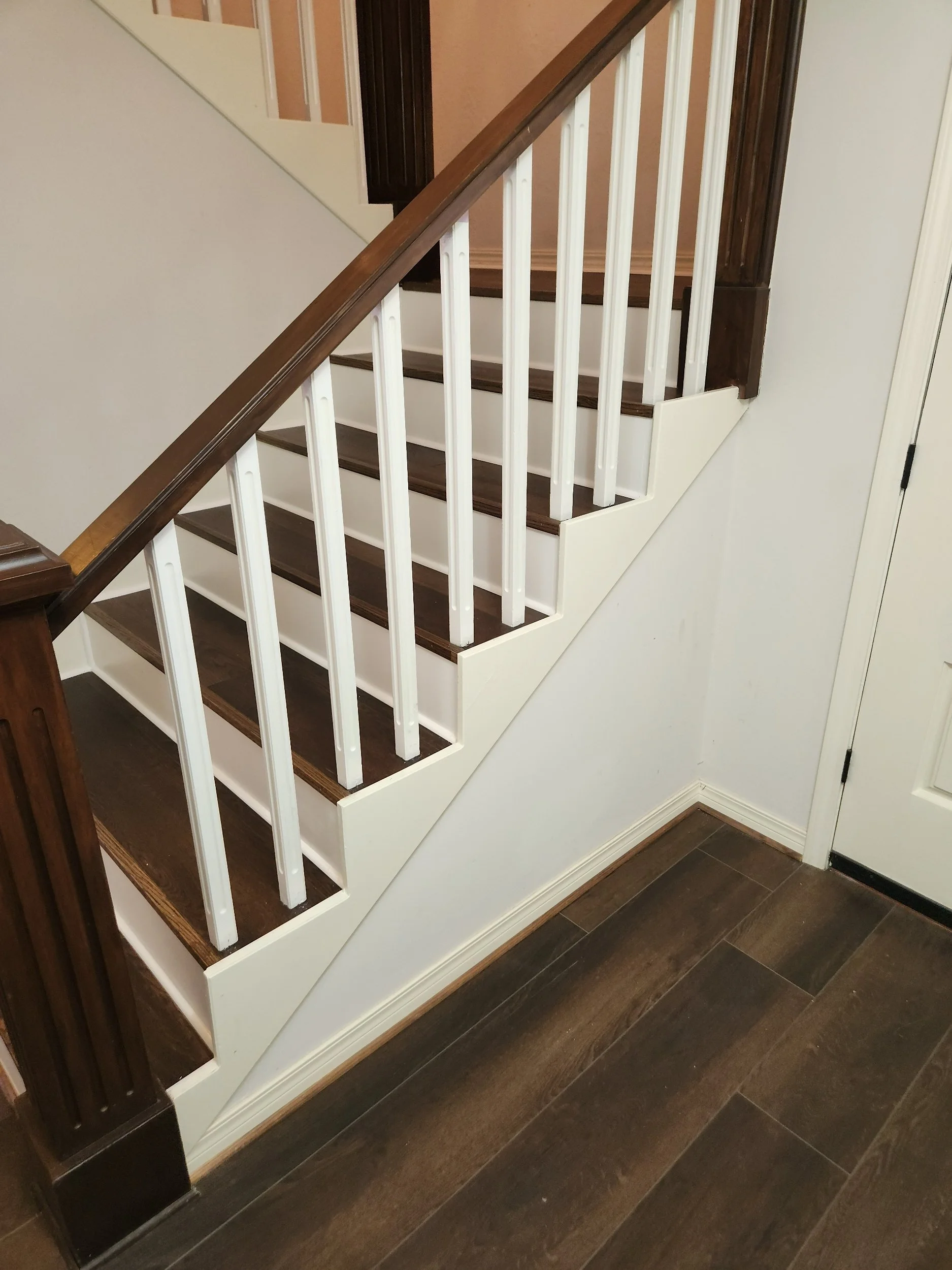 Custom stained hardwood trim with coordinating stair skirt and spindles