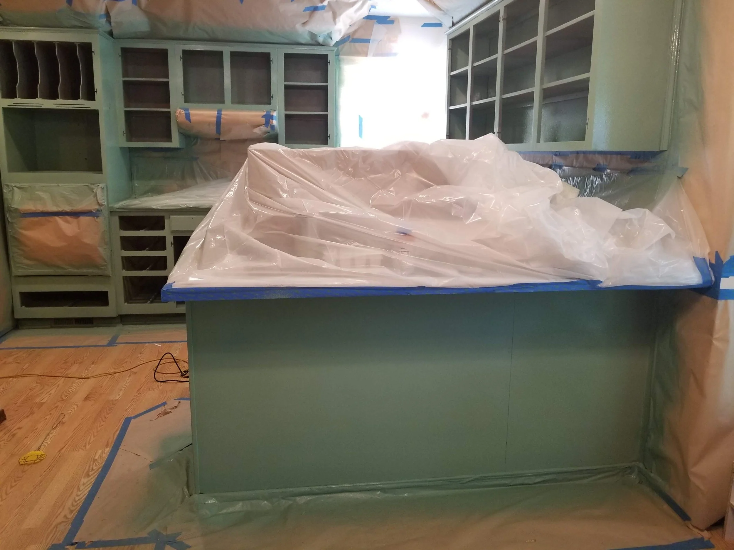 Kitchen cabinets being professionally painted during a kitchen transformation