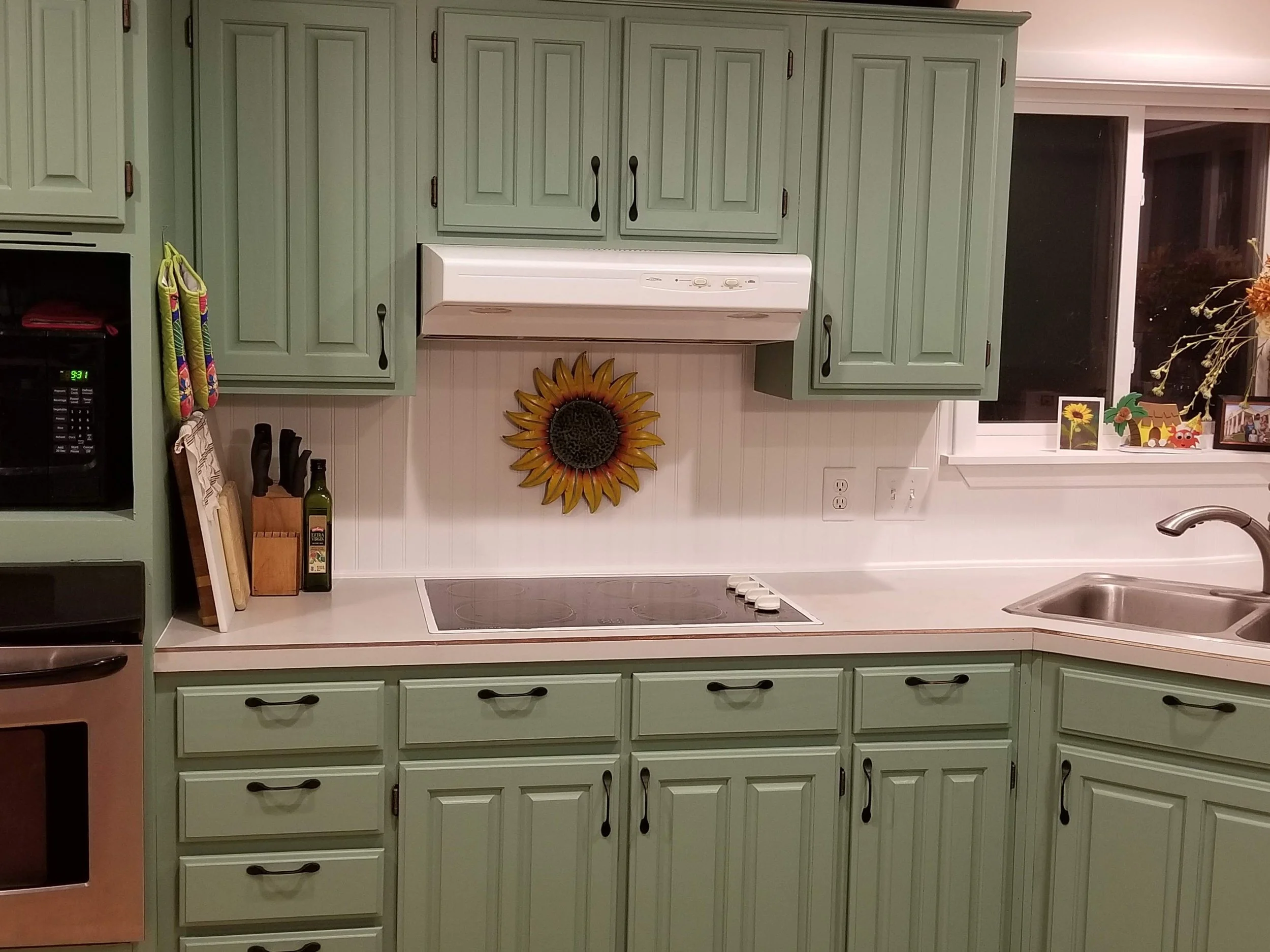 Finished painted kitchen cabinets with new hardware, backsplash and updated countertops