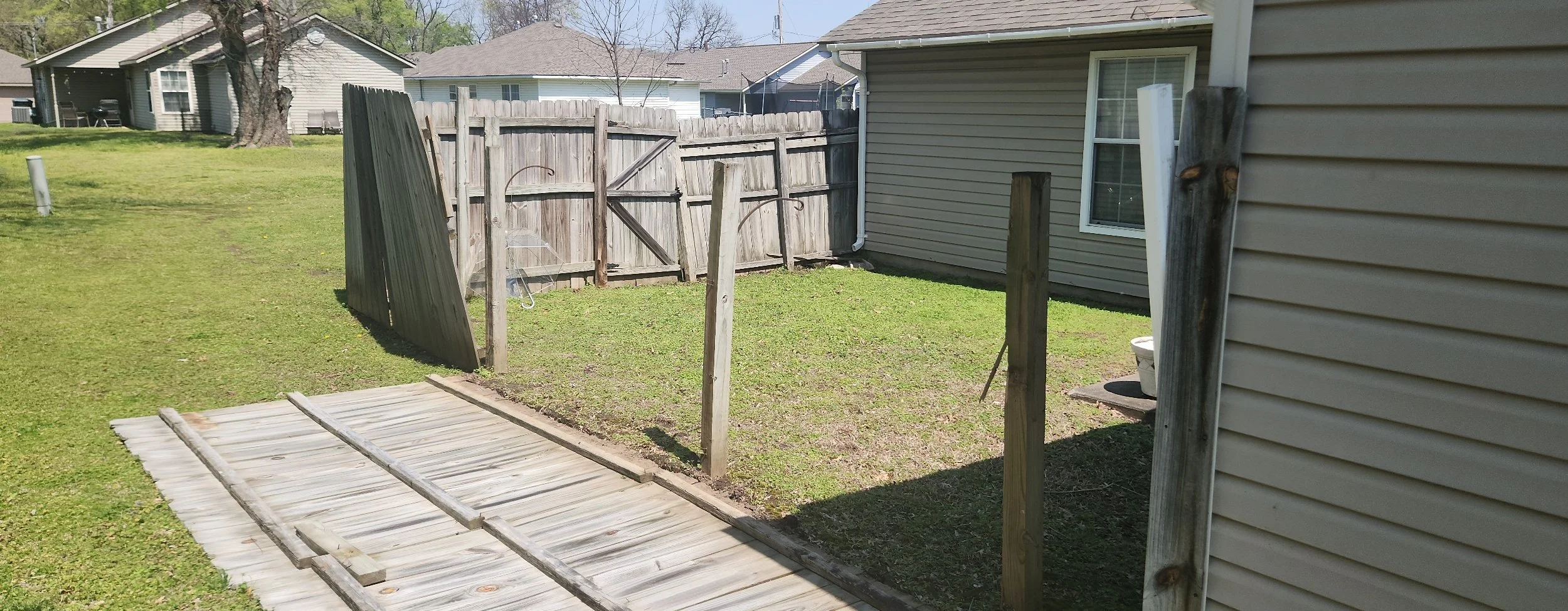 Old wood privacy fence before complete fence replacement