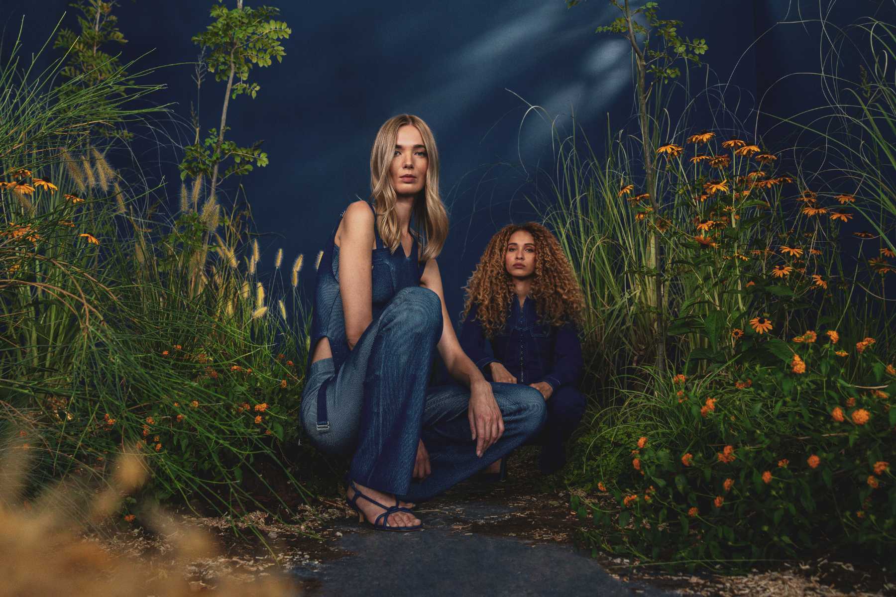 Two women in a field of flowers facing the camera