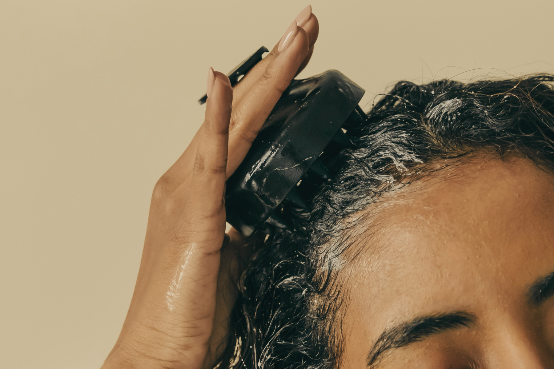 Woman detangling hair with brush