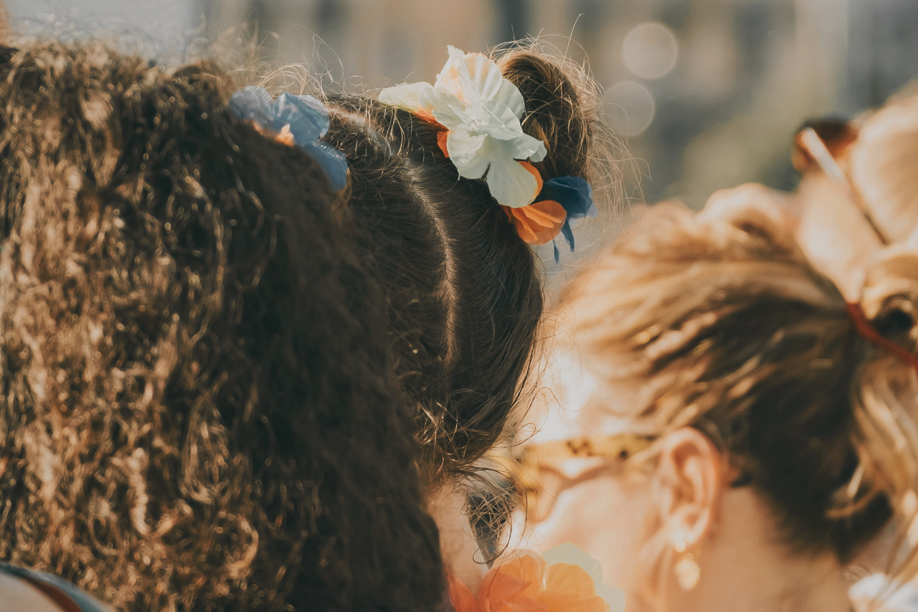 Women at festival with space buns and natural curls