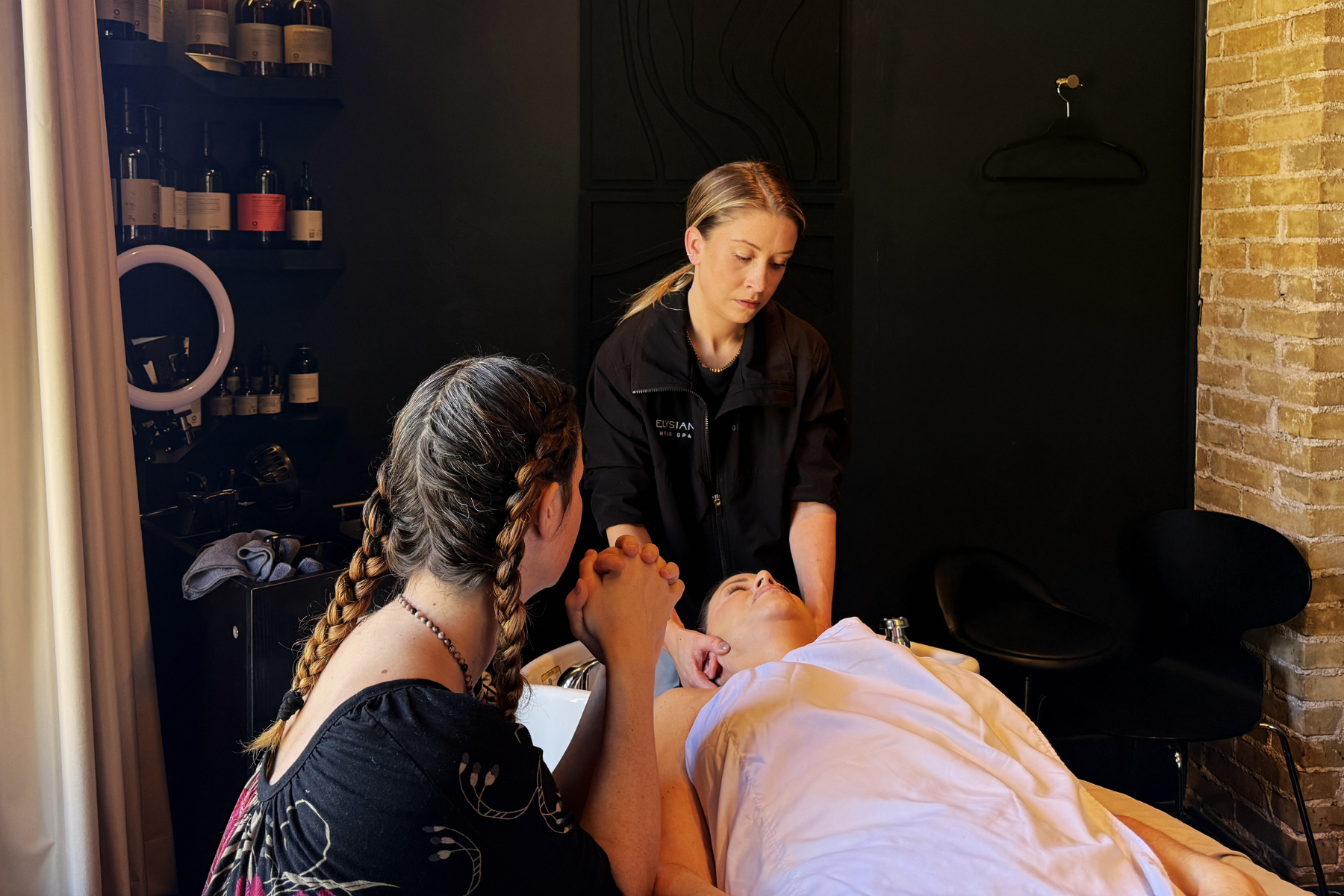 Elysian Head Spa staff trains with Emma Ransome LMT, on massage technique