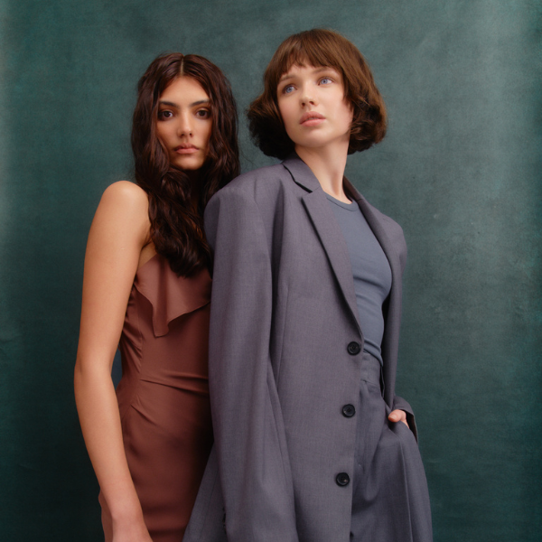 Two women in formal workwear staring at the camera