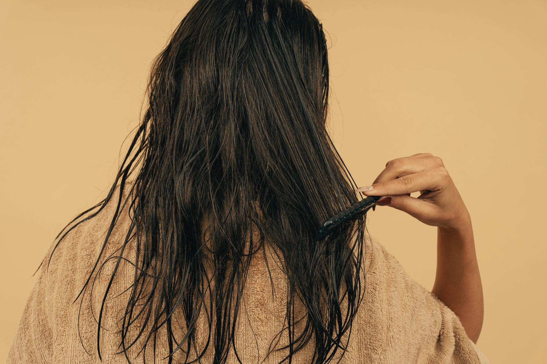 Woman combing freshly-washed hair