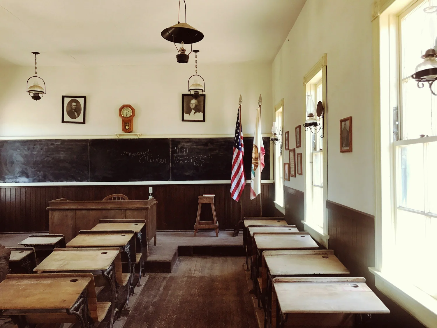A classroom with rows of wooden desks