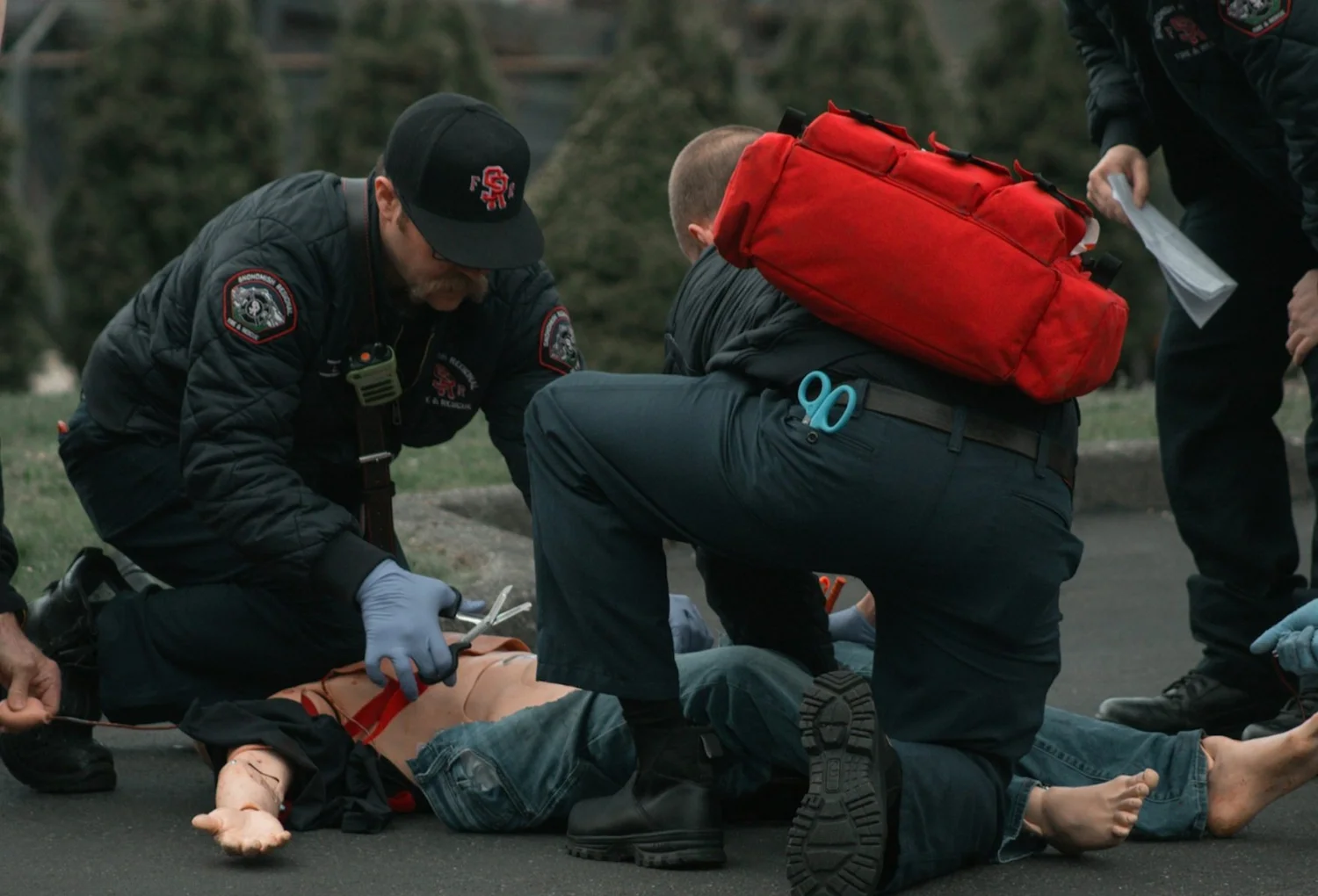 First responders treating a patient on the ground