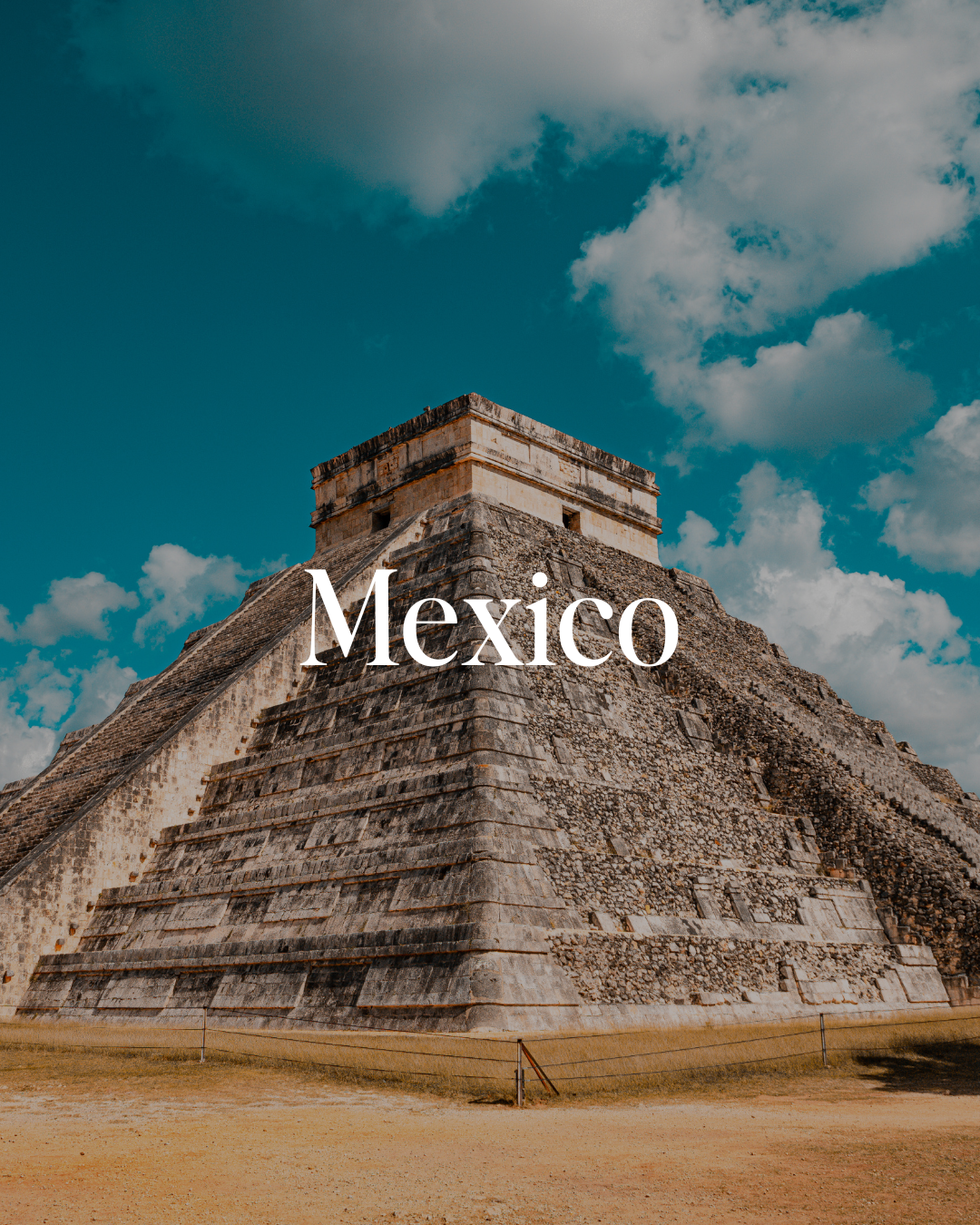 Photograph of a Mayan pyramid at Chichen Itza in Mexico under a partly cloudy sky.