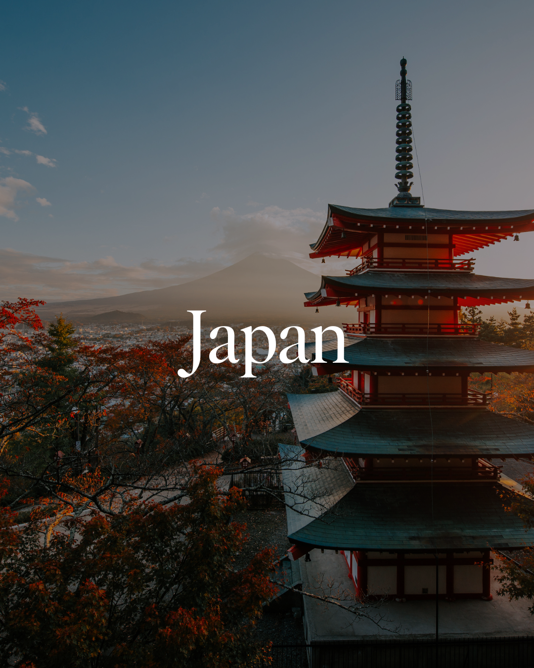 Sunset view of a traditional Japanese pagoda with Mount Fuji in the background and autumn-colored trees in the foreground.