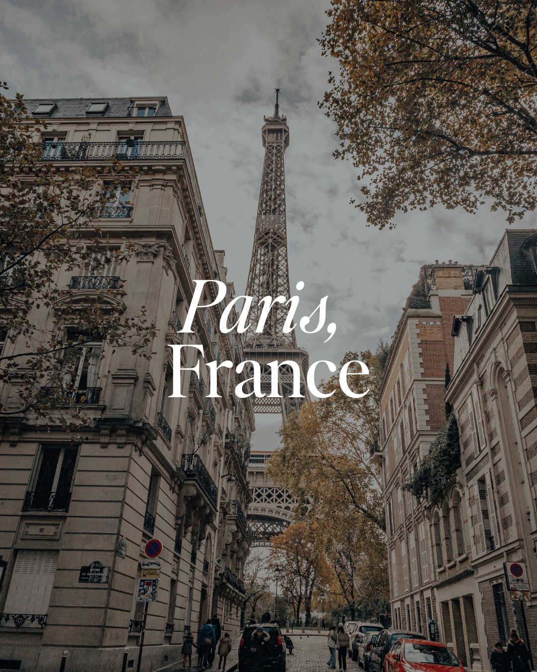 A street scene in Paris, France with the Eiffel Tower in the background, surrounded by classic Parisian buildings and autumn trees.