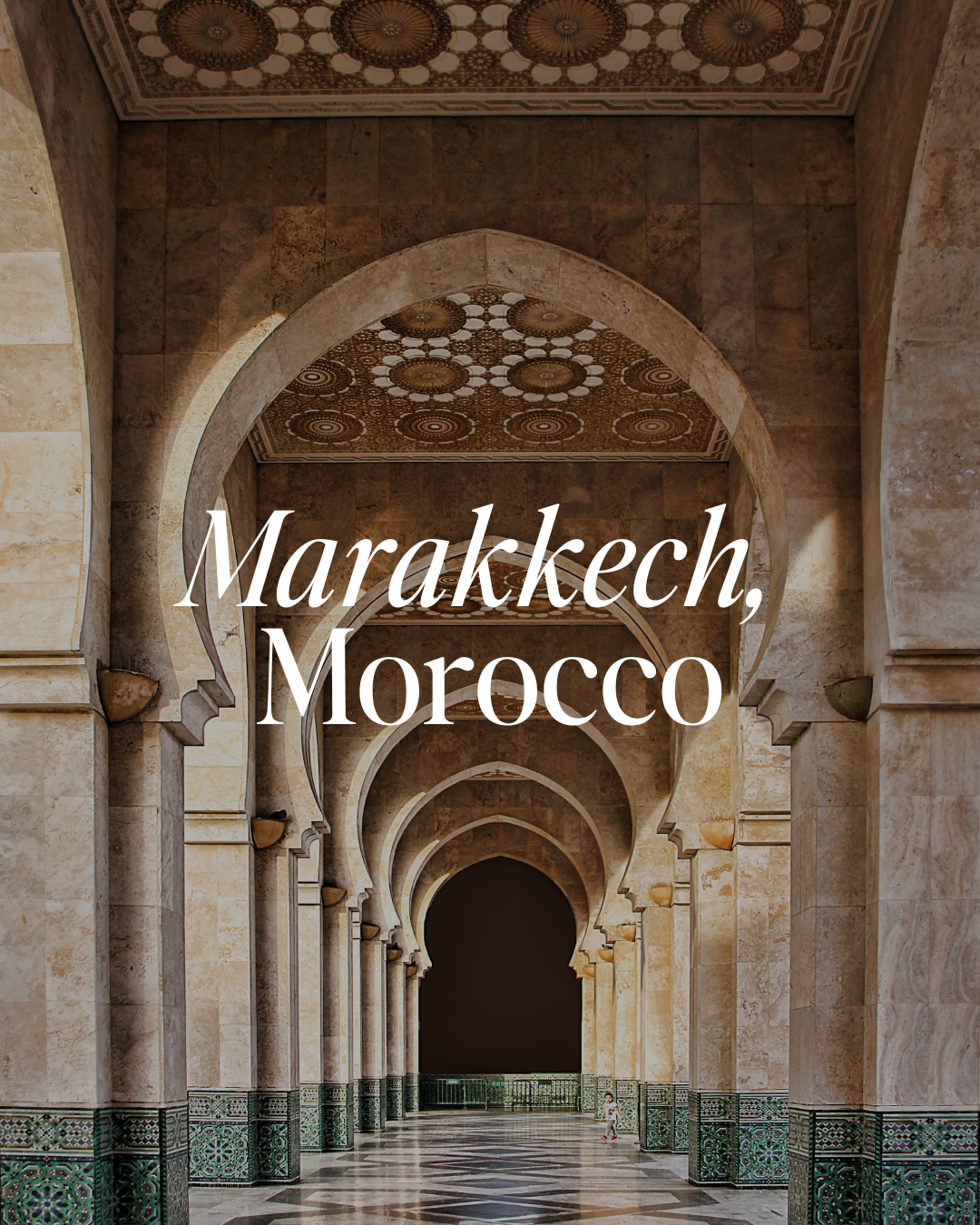 A photo of an ornate walkway in Marrakech, Morocco featuring arches with intricate patterned ceilings and tiled floors.