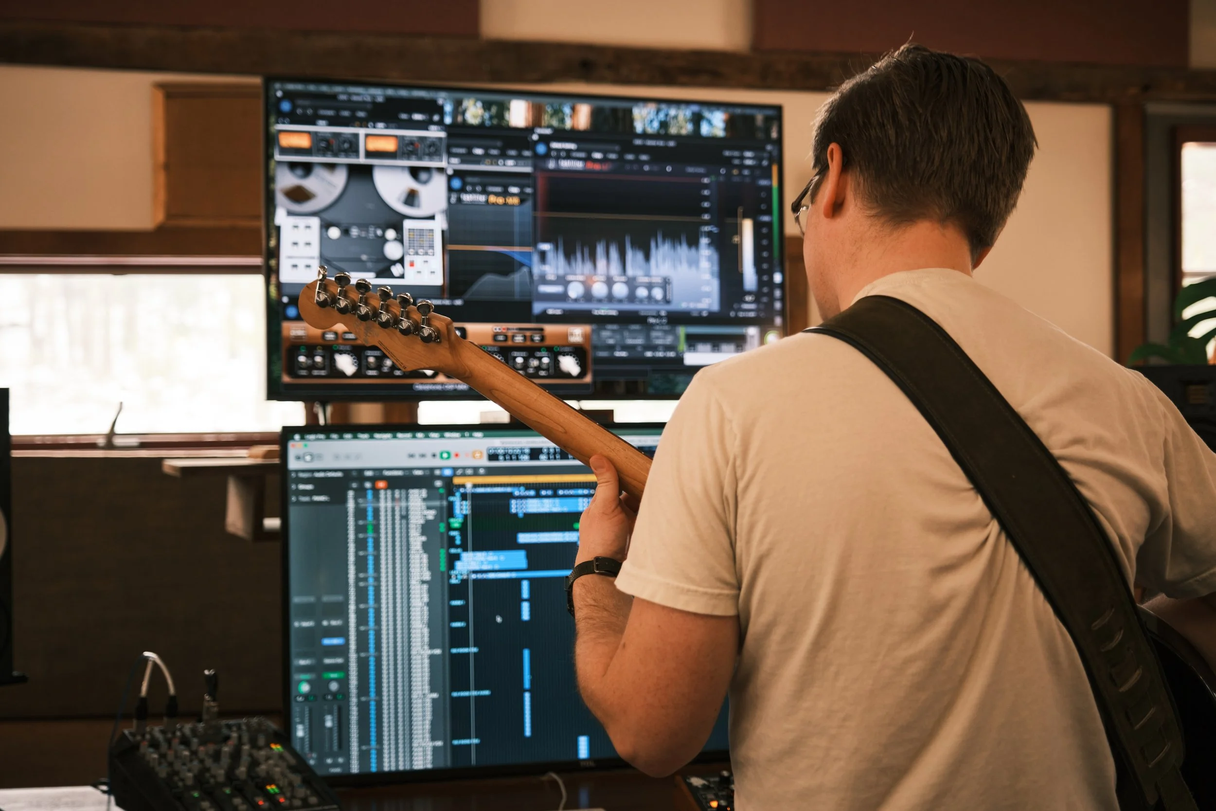 Jon E Guitar in front of Screens.jpeg