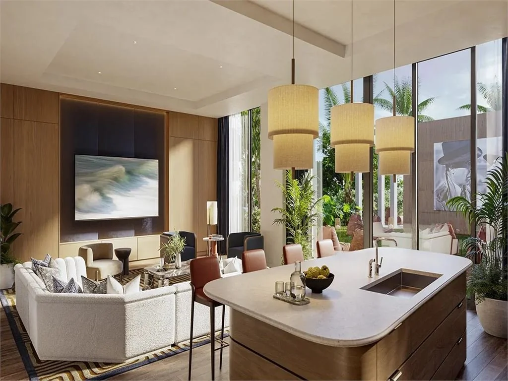 Modern living room with a large curved sofa, armchairs, a flat-screen TV, and floor-to-ceiling windows with outdoor views, accented with hanging pendant lights and indoor plants.