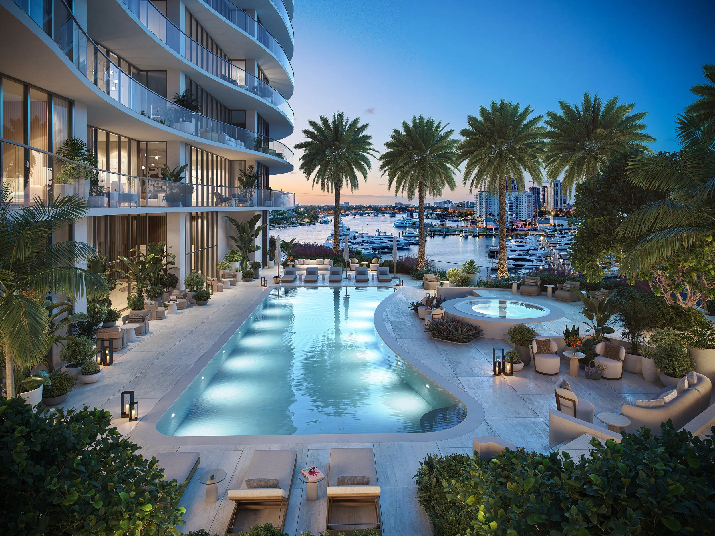 Luxury hotel pool area overlooking a marina with boats, surrounded by palm trees and lounge chairs, during sunset.