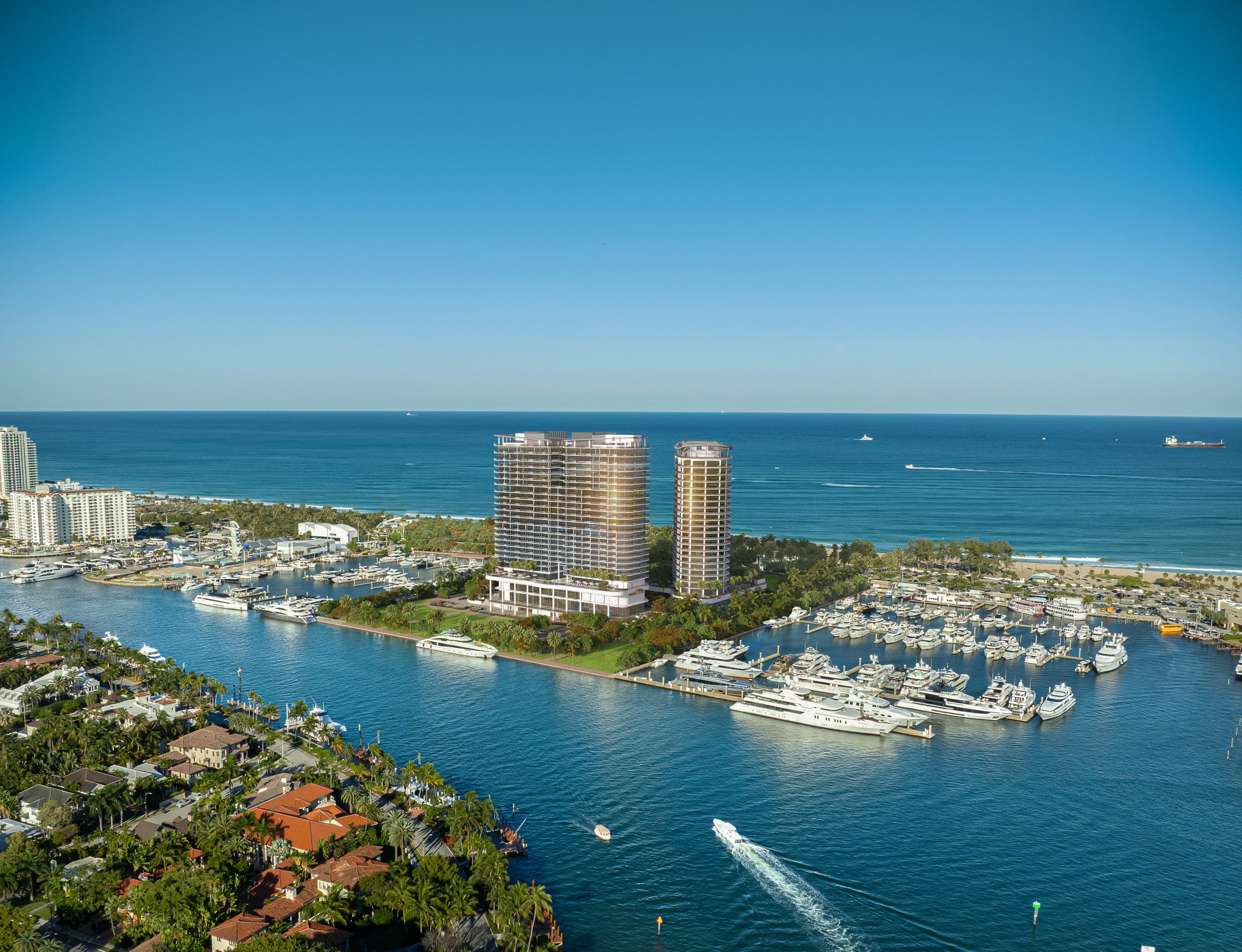 Aerial view of a coastal city with high-rise buildings, a marina filled with yachts, and the ocean in the background.