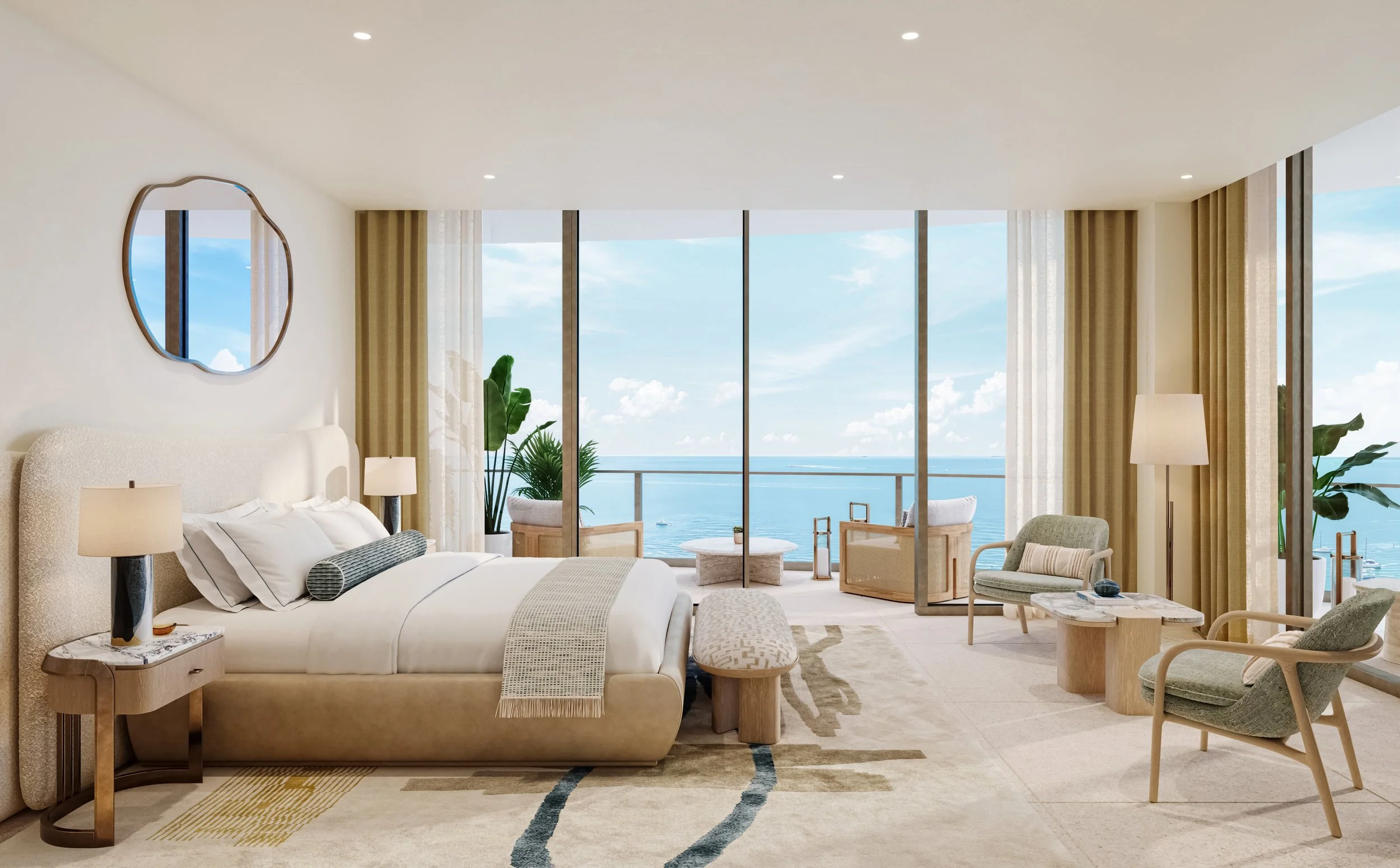 Luxury oceanfront hotel room with a king-size bed, lounge chairs, a small table, potted plants, and large windows overlooking the sea.