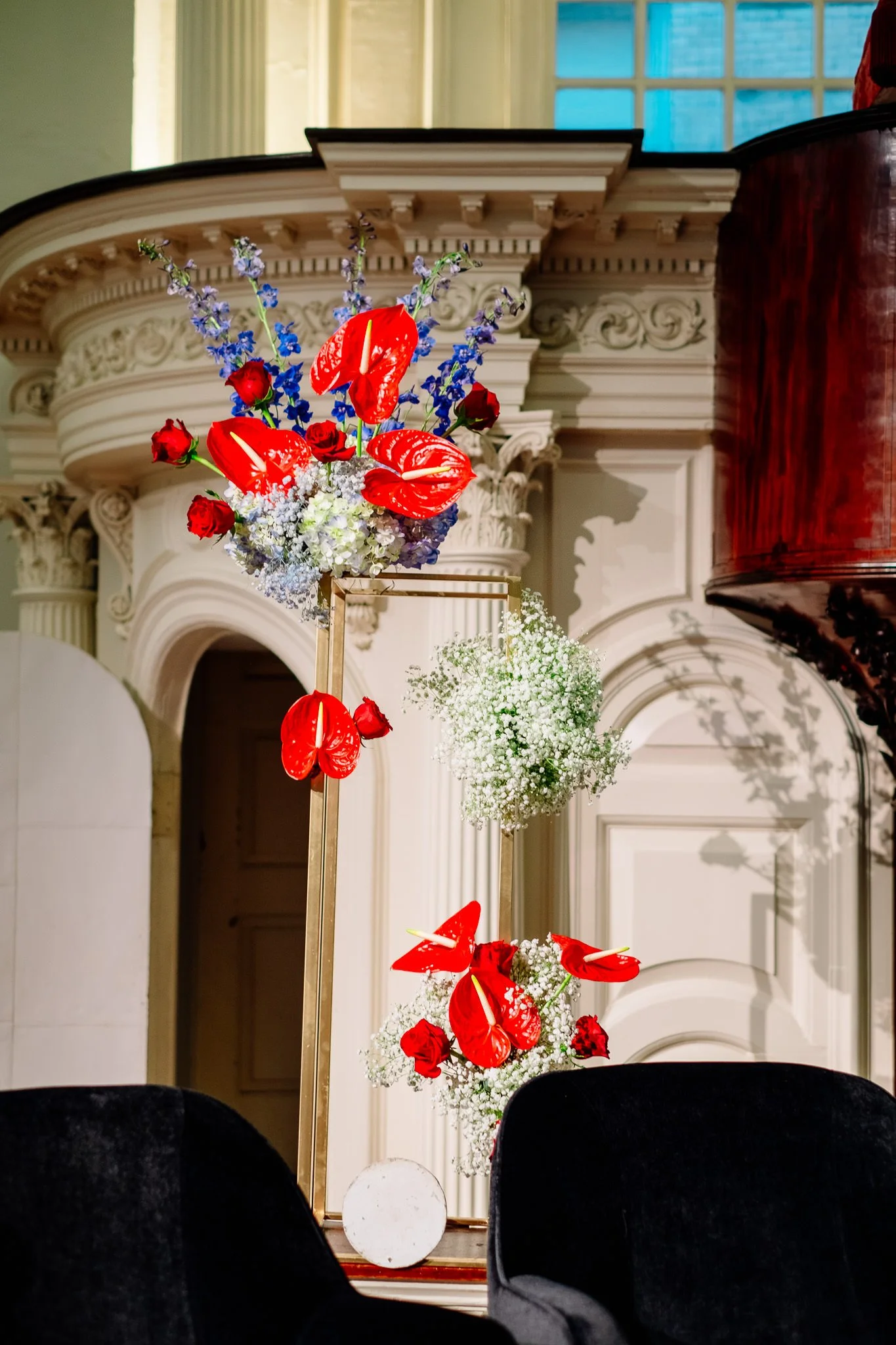  Colorful red and blue floral arrangements sitting on a stage  