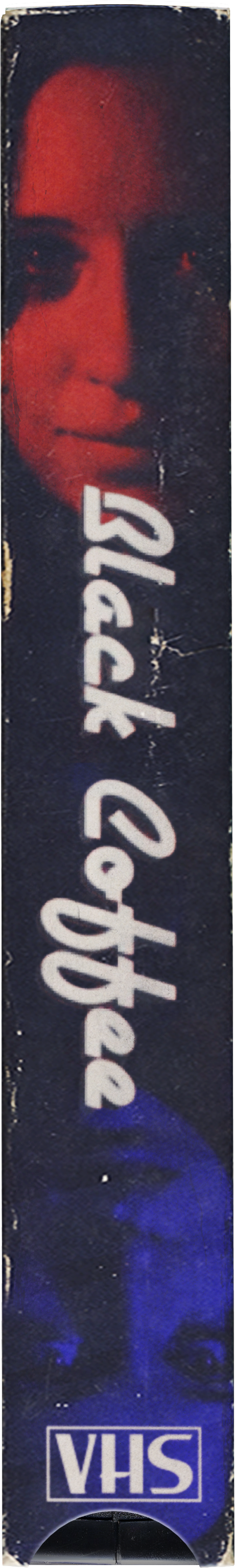 A VHS tape featuring an image of a woman's face with dark hair, partially visible. The tape has the words 'Black Coffee' written on it.
