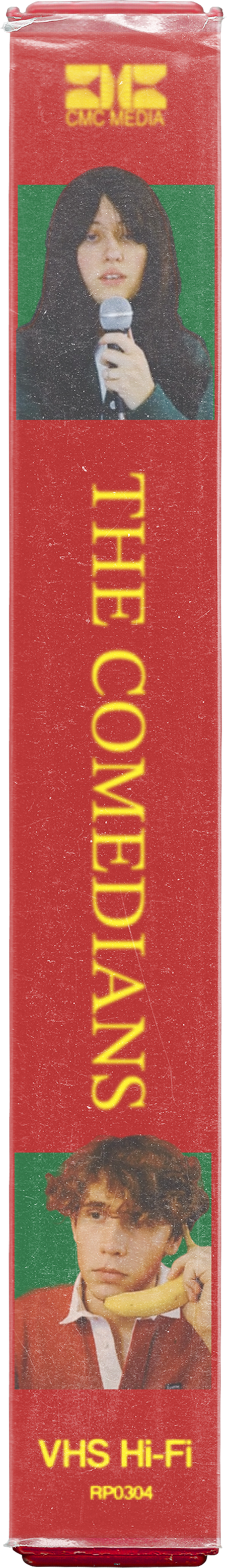 A VHS tape with a red background, featuring images of a woman holding a microphone at the top and a man holding a banana at the bottom. The tape's title is 'The Comedians,' with additional text 'VHS Hi-Fi' and a code 'RP0304' on it.
