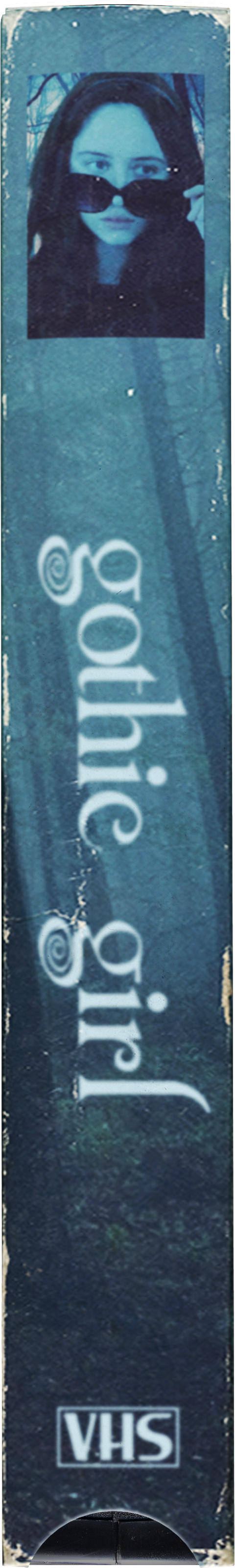 A woman with dark hair, wearing sunglasses, appears on the cover of a VHS tape titled "Gothic Girl." The background features trees with blue hues, and the VHS logo is visible at the bottom.