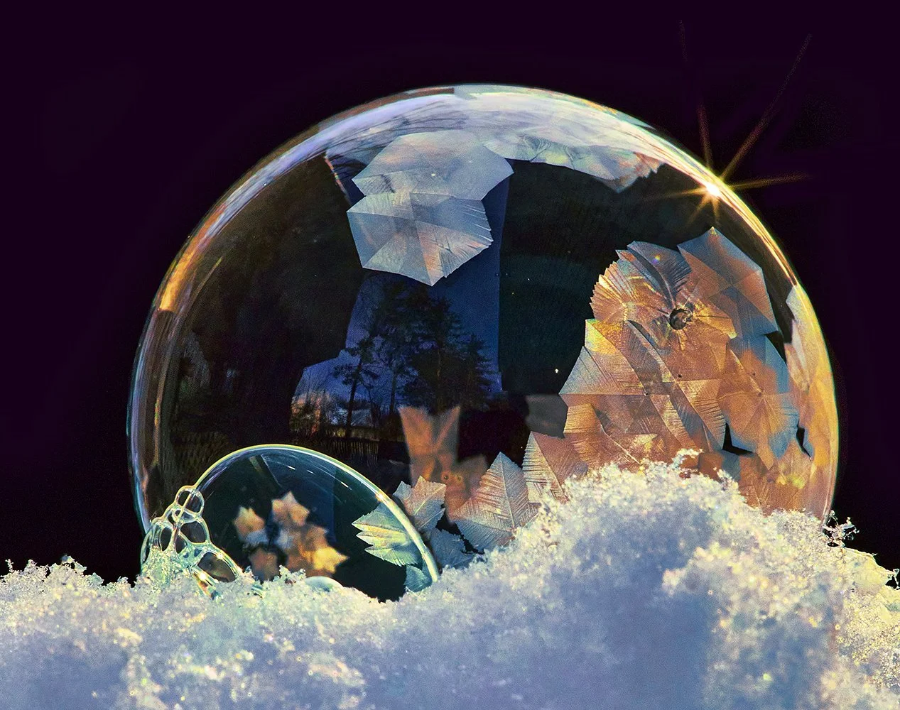 A photograph of a winter soap bubble with ice crystals in subzero weather, only to exist for a moment and then it bursts.