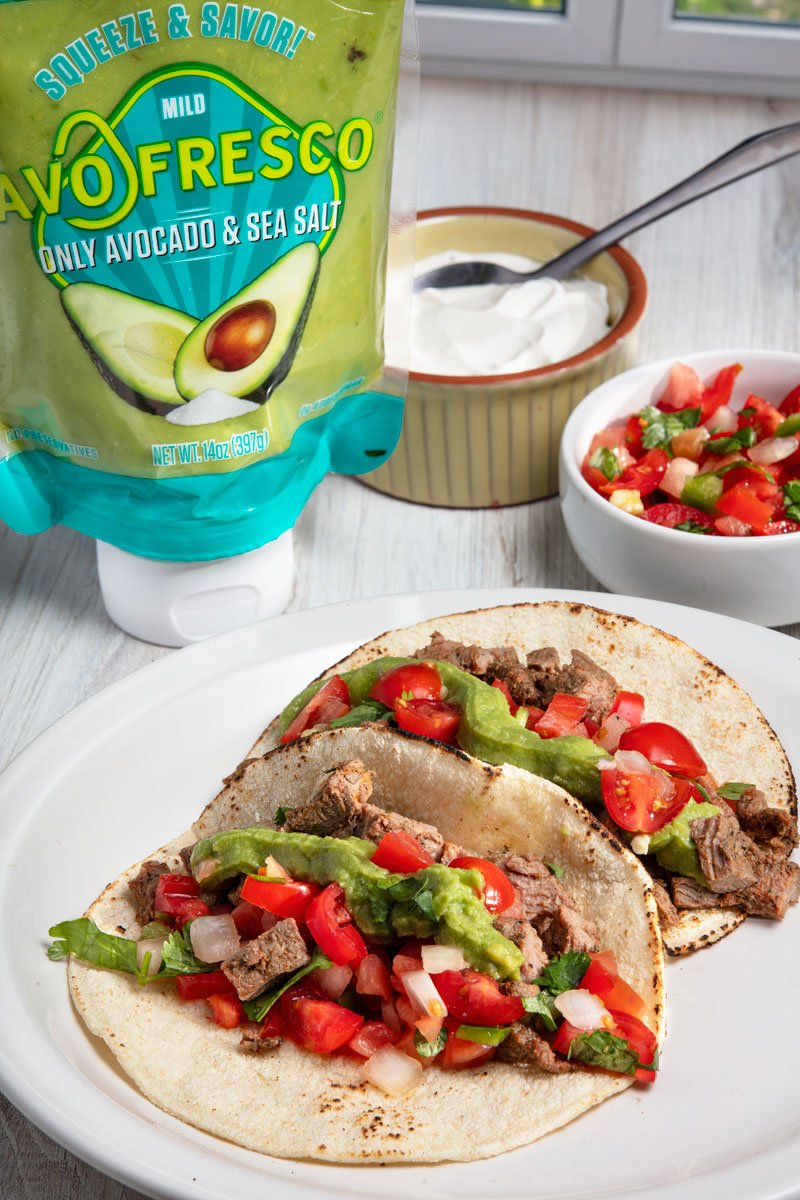 AvoFrescho guacamole next to steak tacos.