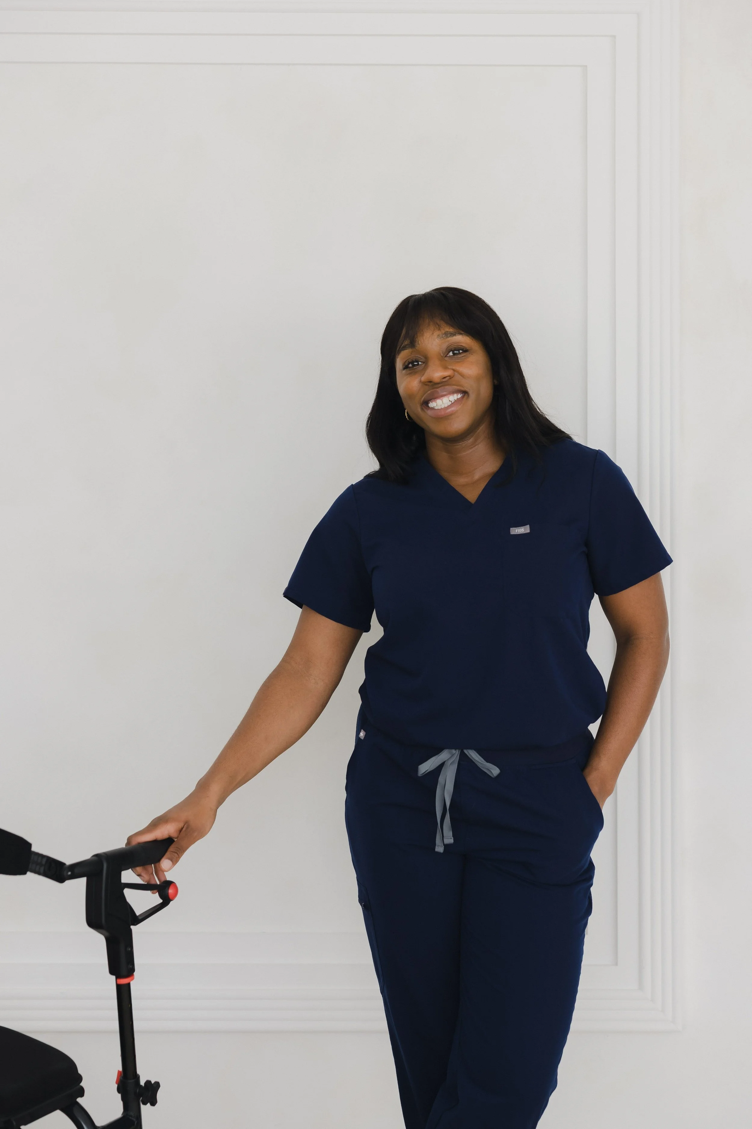 Occupational therapist in scrubs demonstrating walker use during mobility assessment Ottawa