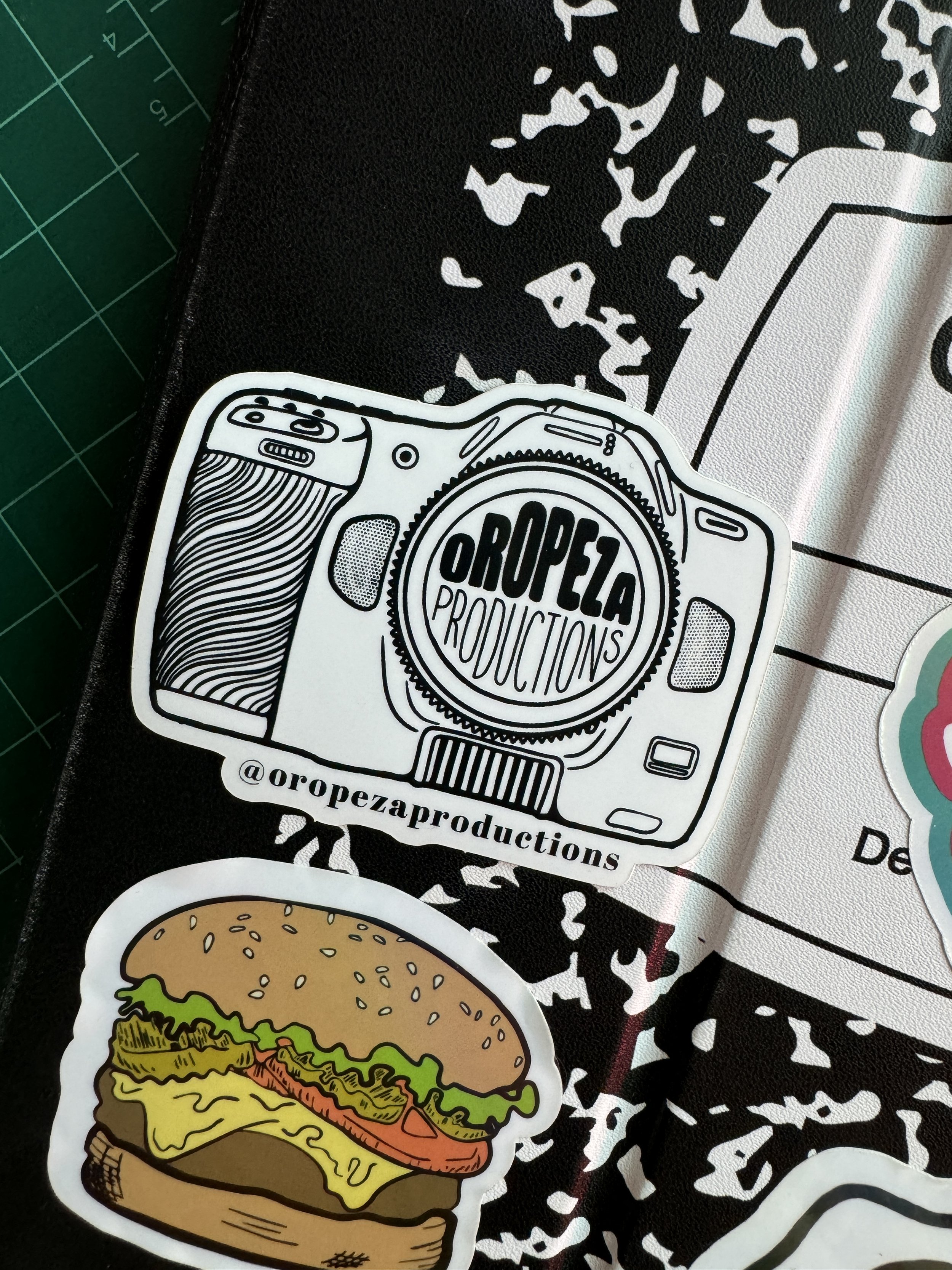 Image of an illustrated camera sticker for oropeza productions