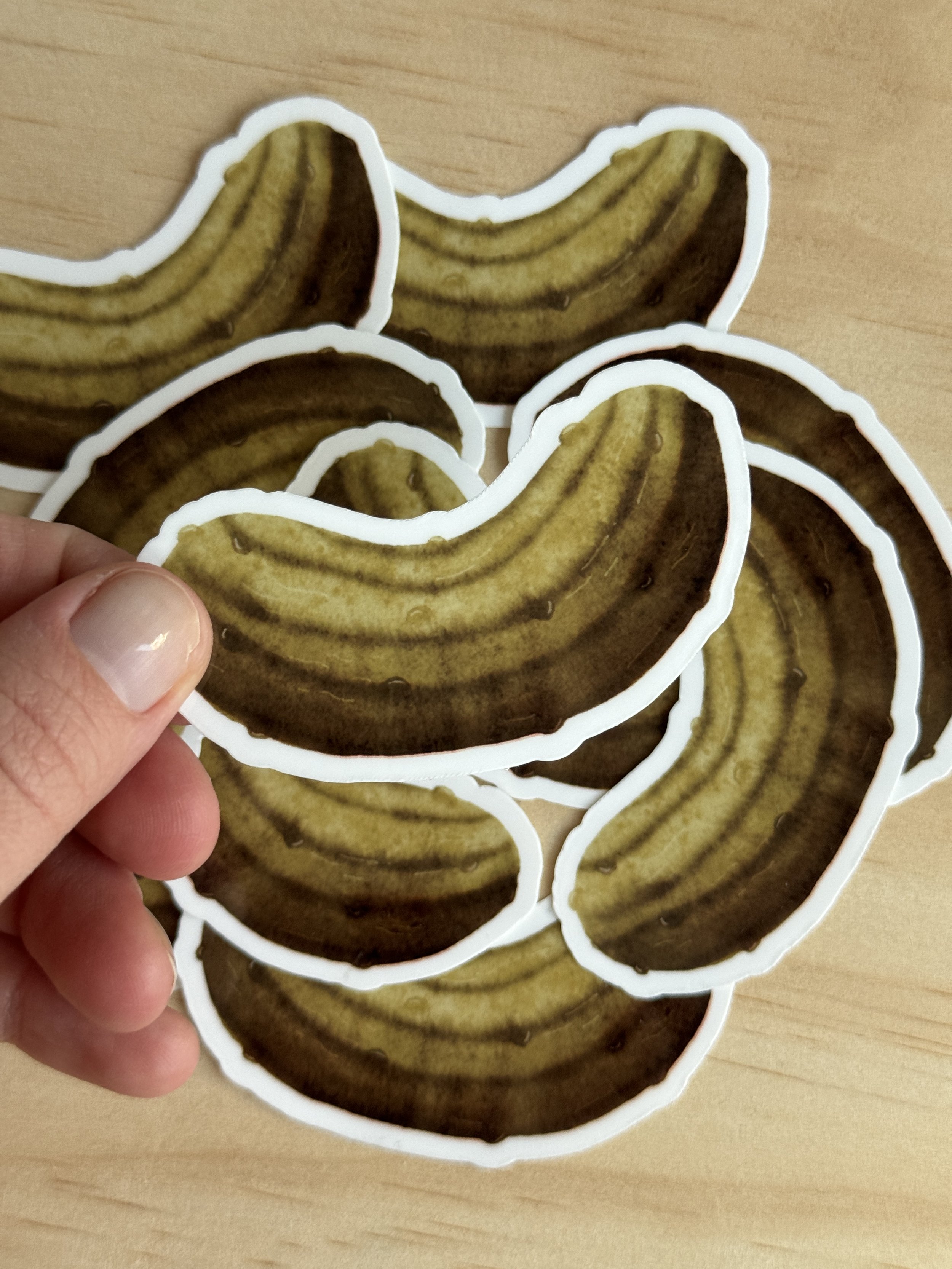Hand holding watercolor pickle sticker