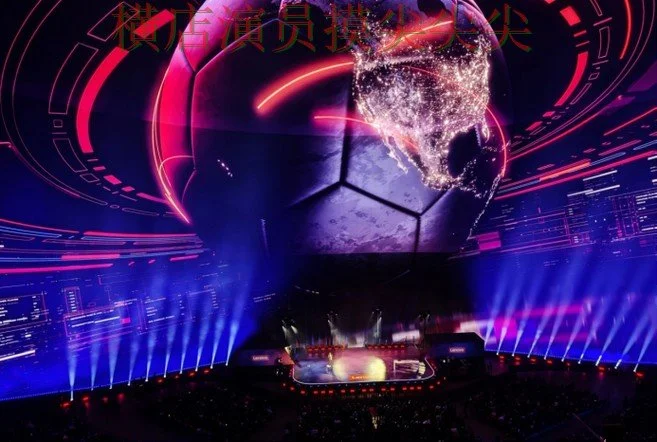 A large soccer ball with a digital world map projected on it, surrounded by vibrant red, purple, and blue lights, in a stadium setting with stage lighting and screens around.