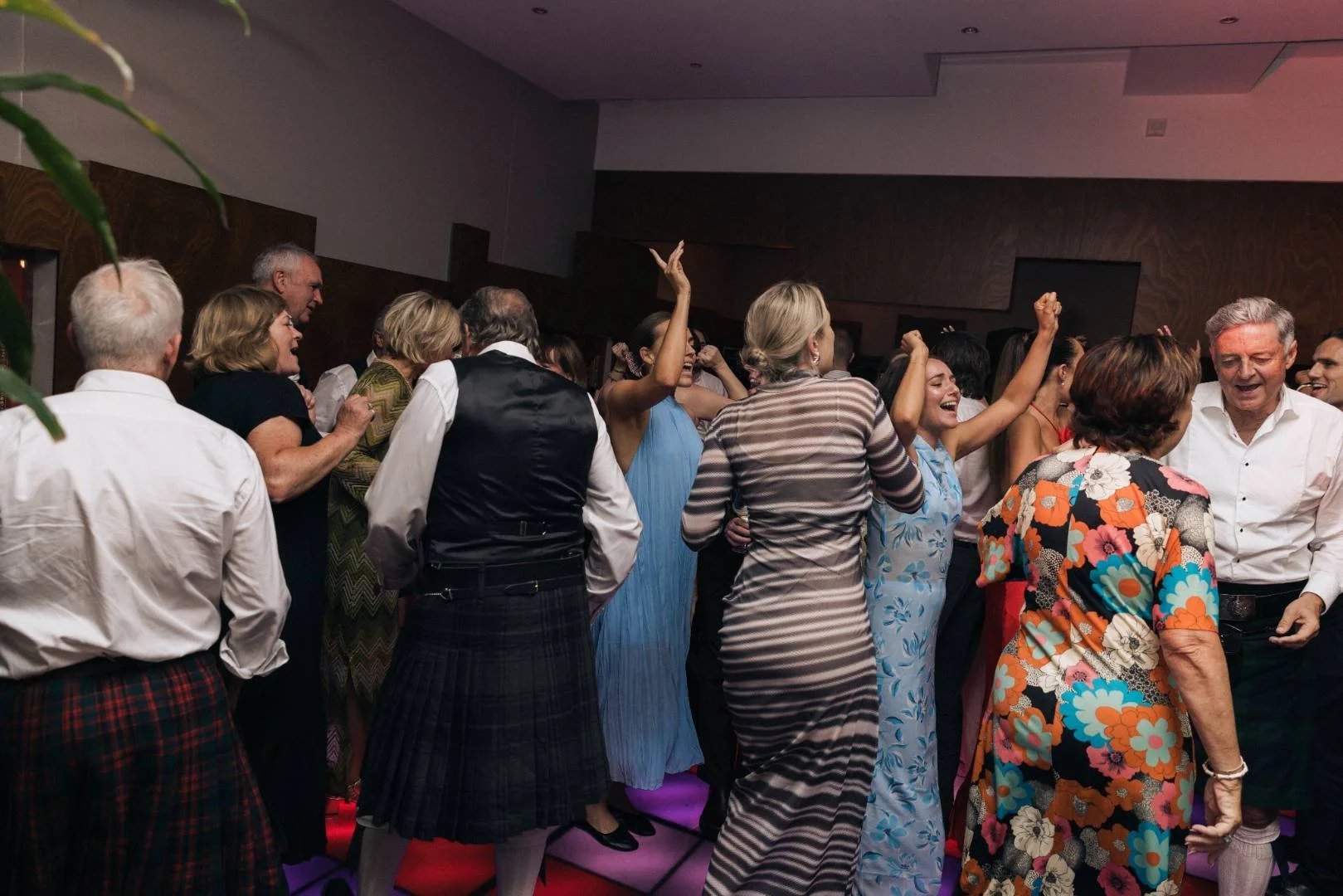 People dancing and celebrating at a party or social event indoors.