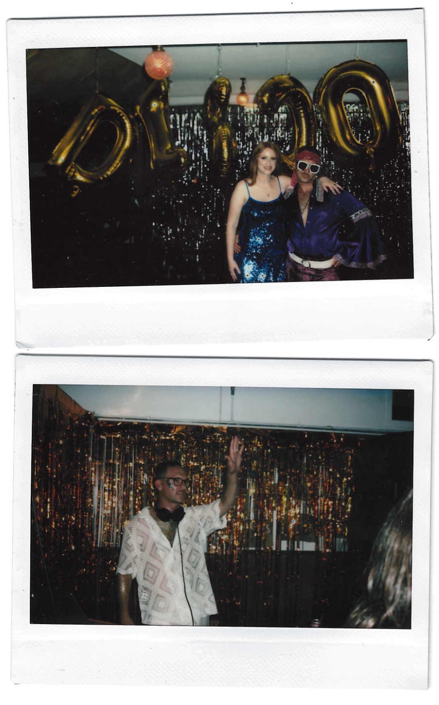 Two Polaroid photos from a celebratory event. The top photo shows two people, a woman in a blue sequined dress and a man wearing large white sunglasses, a purple jacket, and a red cap, standing in front of gold balloon letters spelling 'DILO'. The background is decorated with shiny black and gold streamers and balloons. The bottom photo features a man with glasses, headphones around his neck, wearing a white patterned shirt, raising his hand while DJing in front of a shimmering gold curtain, at the same event.