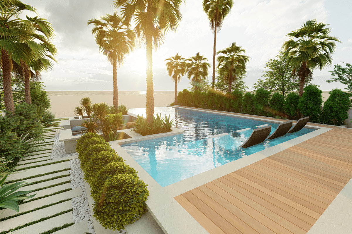 A luxurious outdoor pool area with palm trees, greenery, and a view of the beach at sunset.