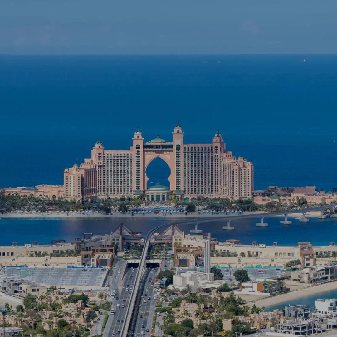 Photo of Atlantis The Palm hotel in Dubai, with its distinctive arch design, situated by the ocean.