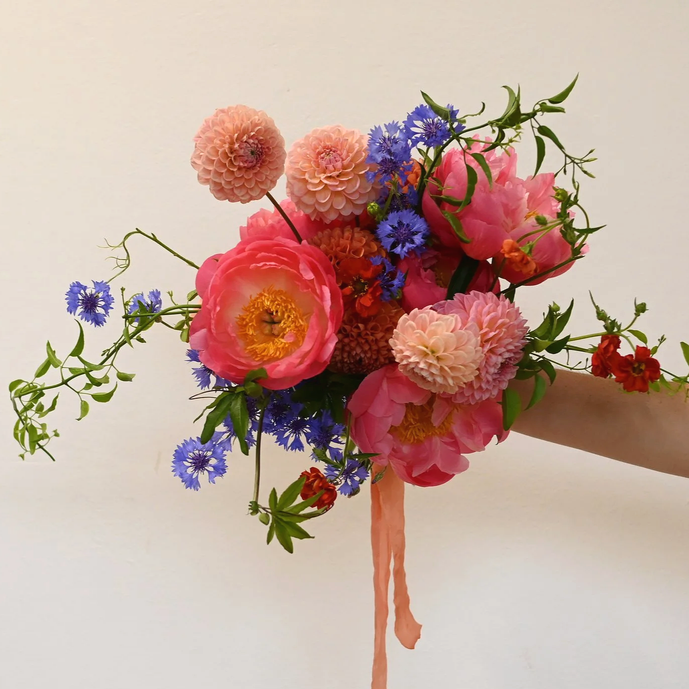 colourful summer bridal bouquet, with peonies, cornflowers, dahlias and jasmine