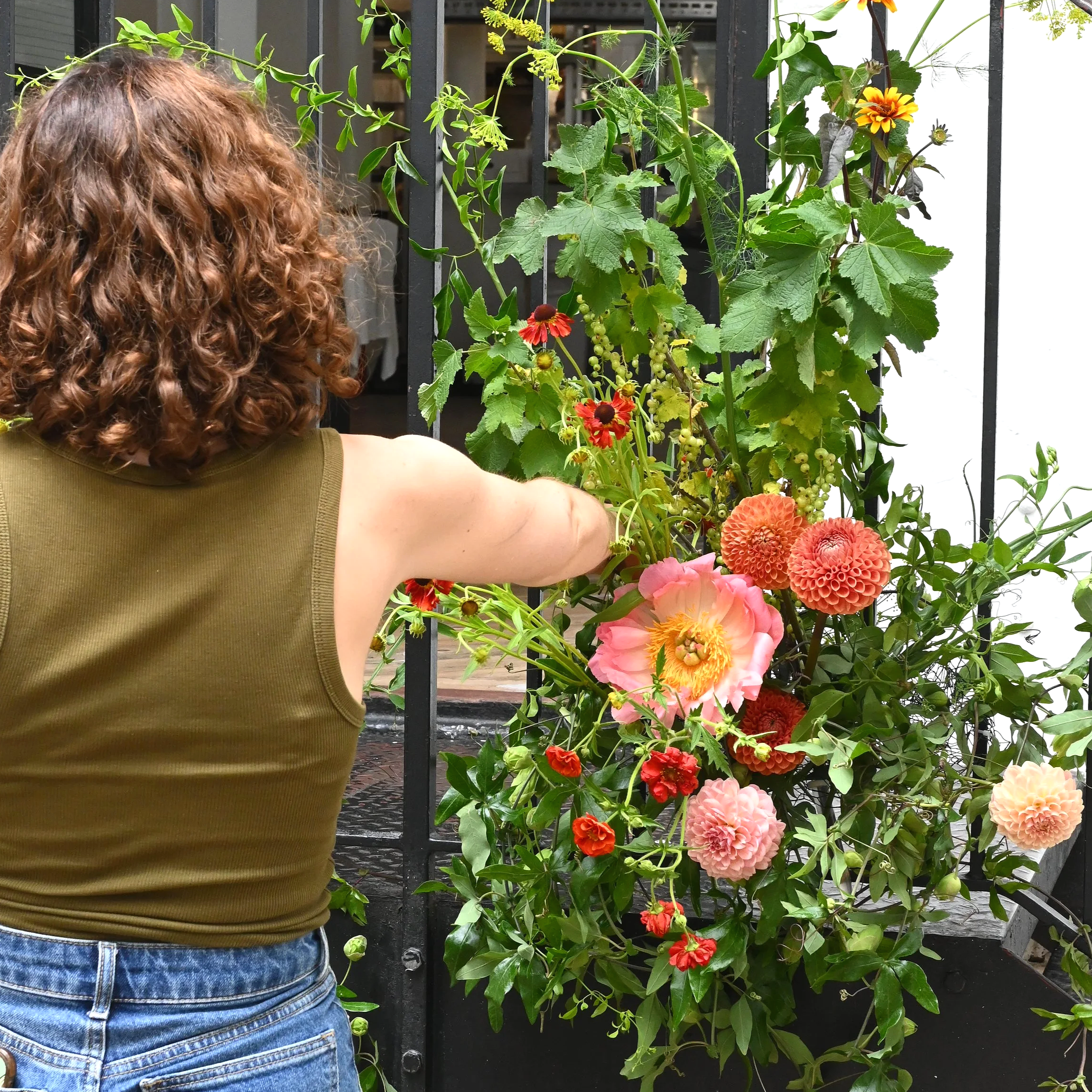 Florist arranging wedding flowers in a restaurant in London, using seasonal flowers in June